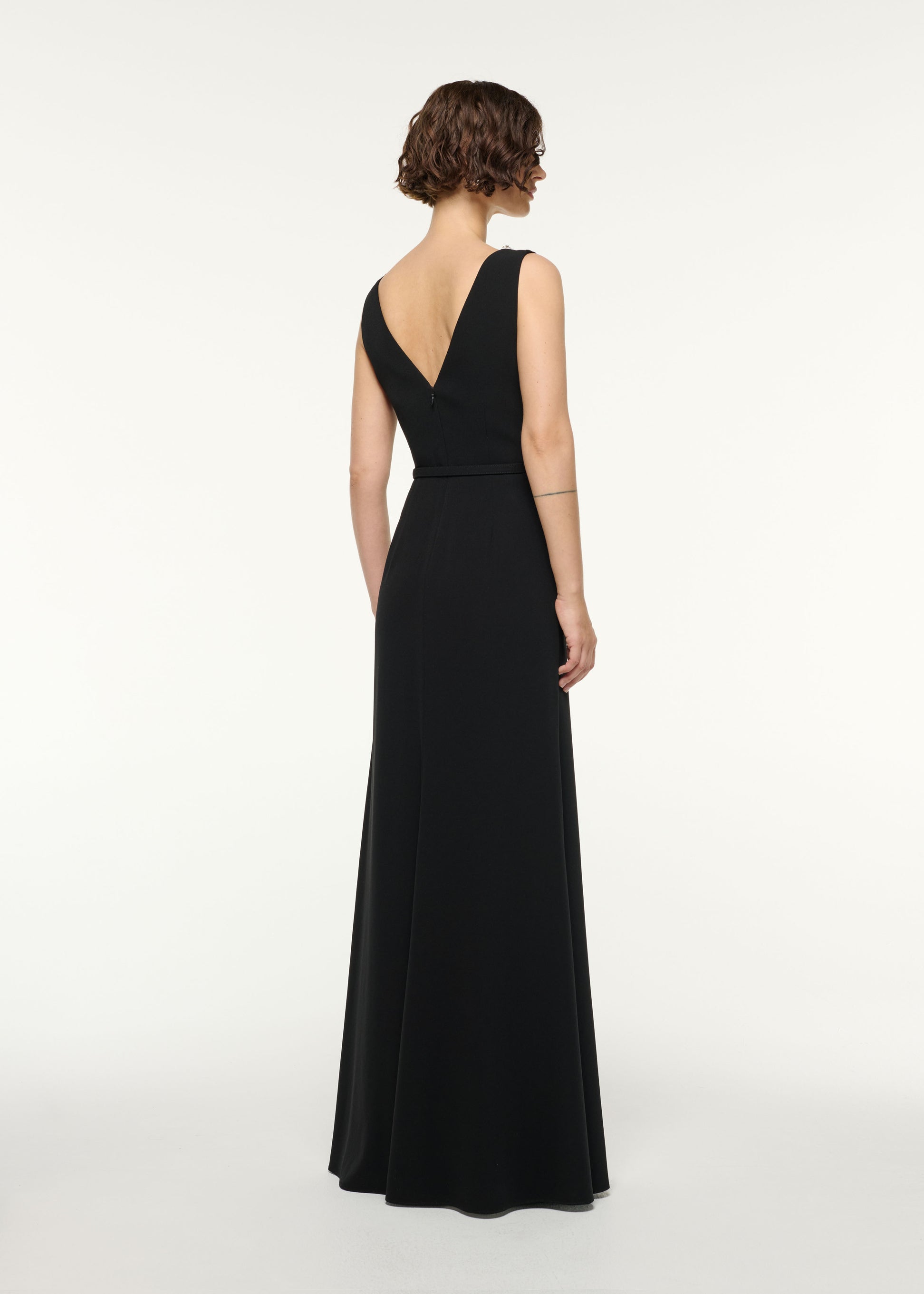 Back view of a model wearing the Crystal Neckline Monochrome Gathered Gown in Monochrome