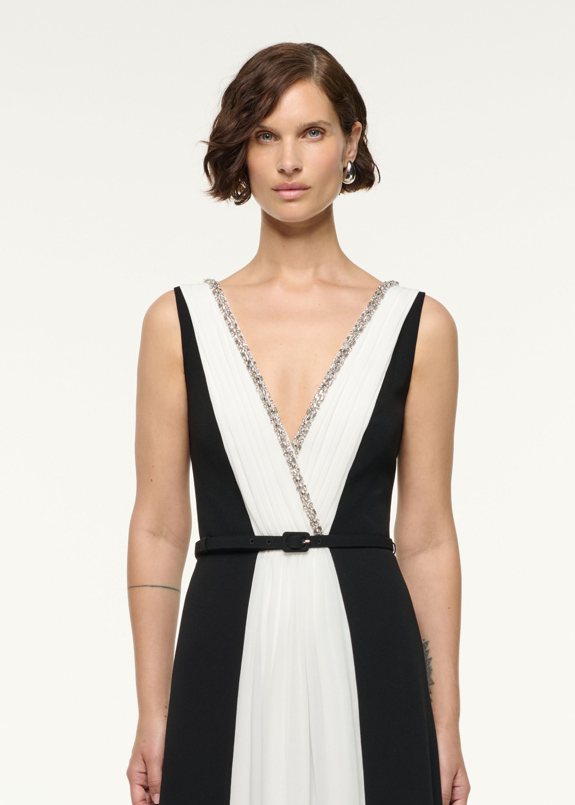 Close up of a model wearing the Crystal Neckline Monochrome Gathered Gown in Monochrome