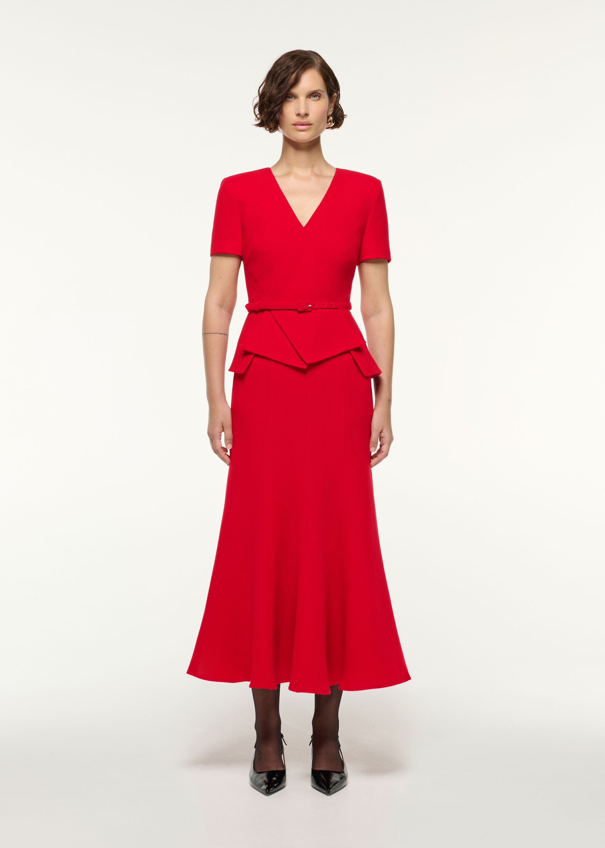 Front view of a model wearing the Wool Origami Peplum Drape Dress in Red