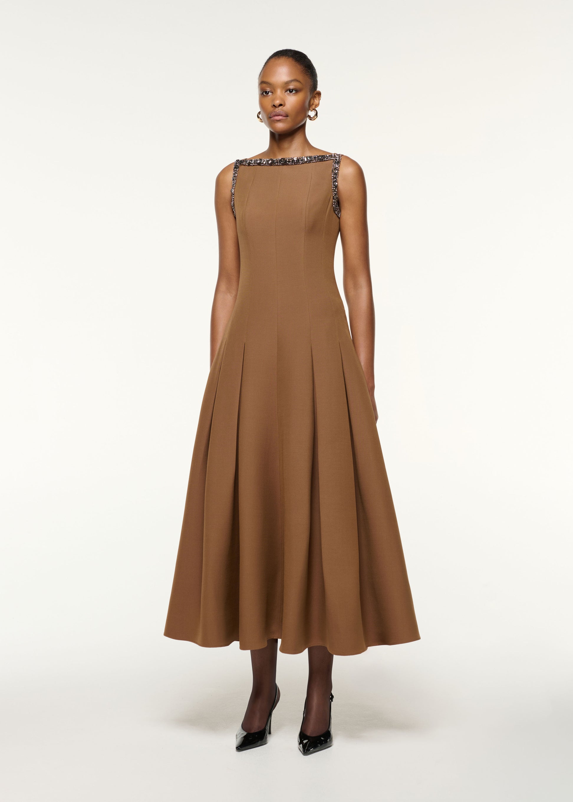 Side view of a model wearing the Wool Silk Crystal Trimmed Pleat Dress in Brown