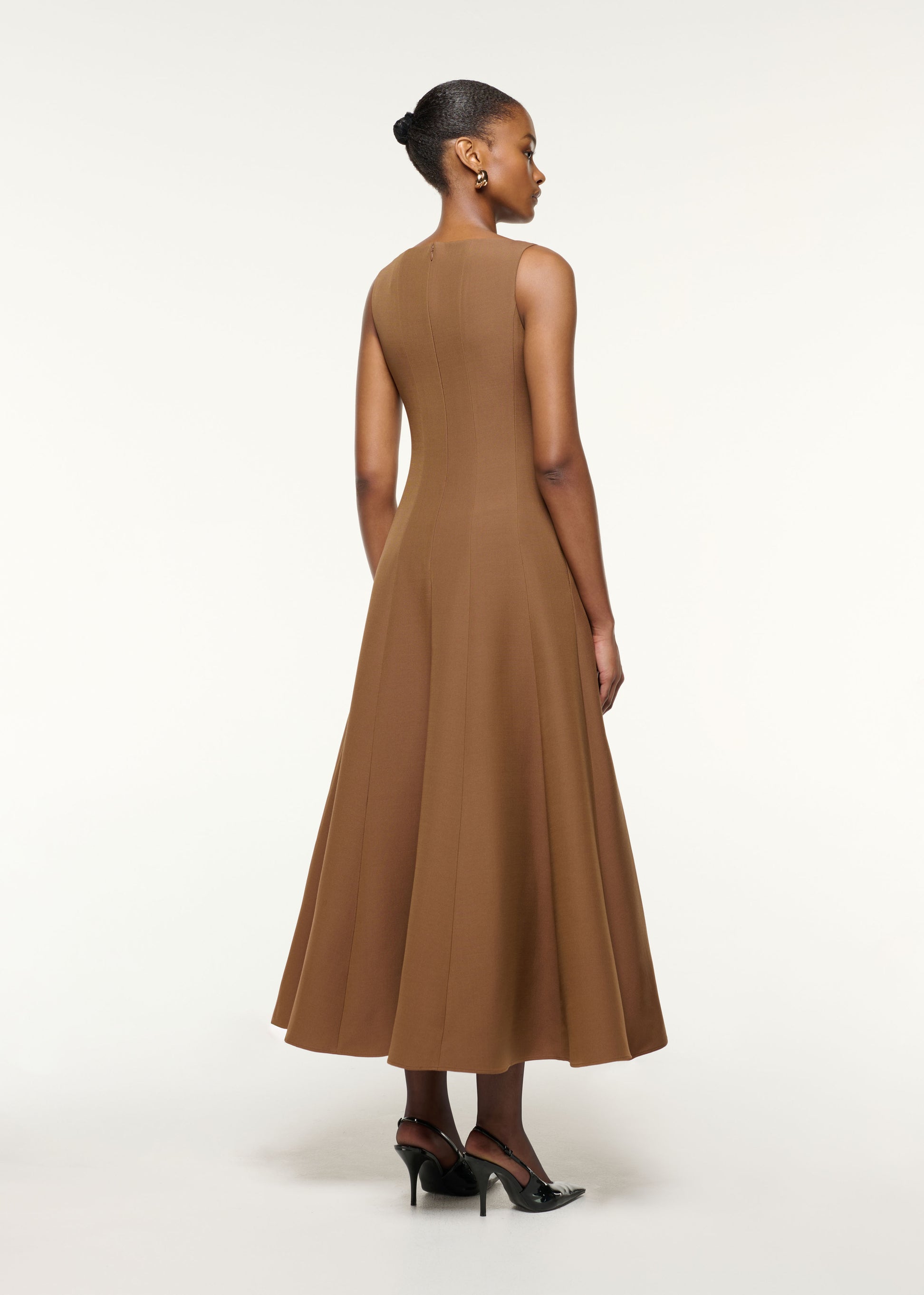 Back view of a model wearing the Wool Silk Crystal Trimmed Pleat Dress in Brown