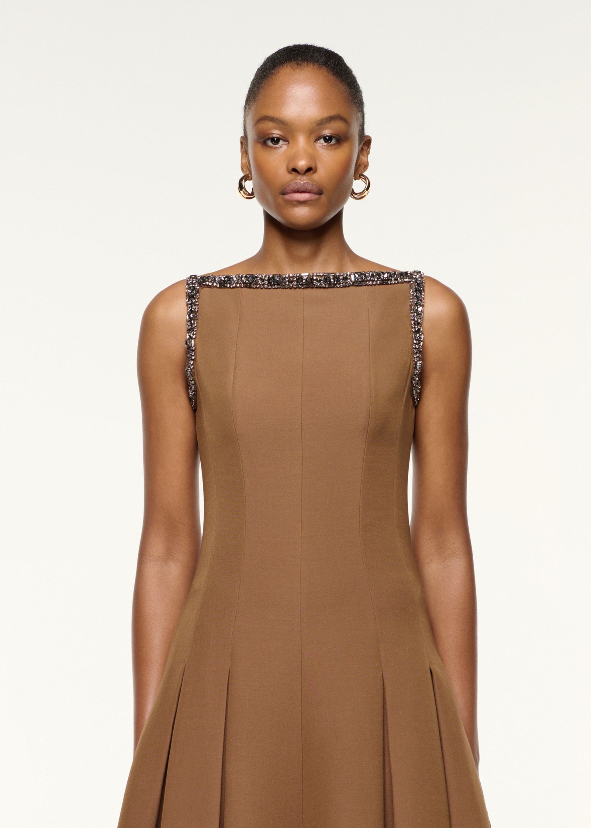 Close up of a model wearing the Wool Silk Crystal Trimmed Pleat Dress in Brown