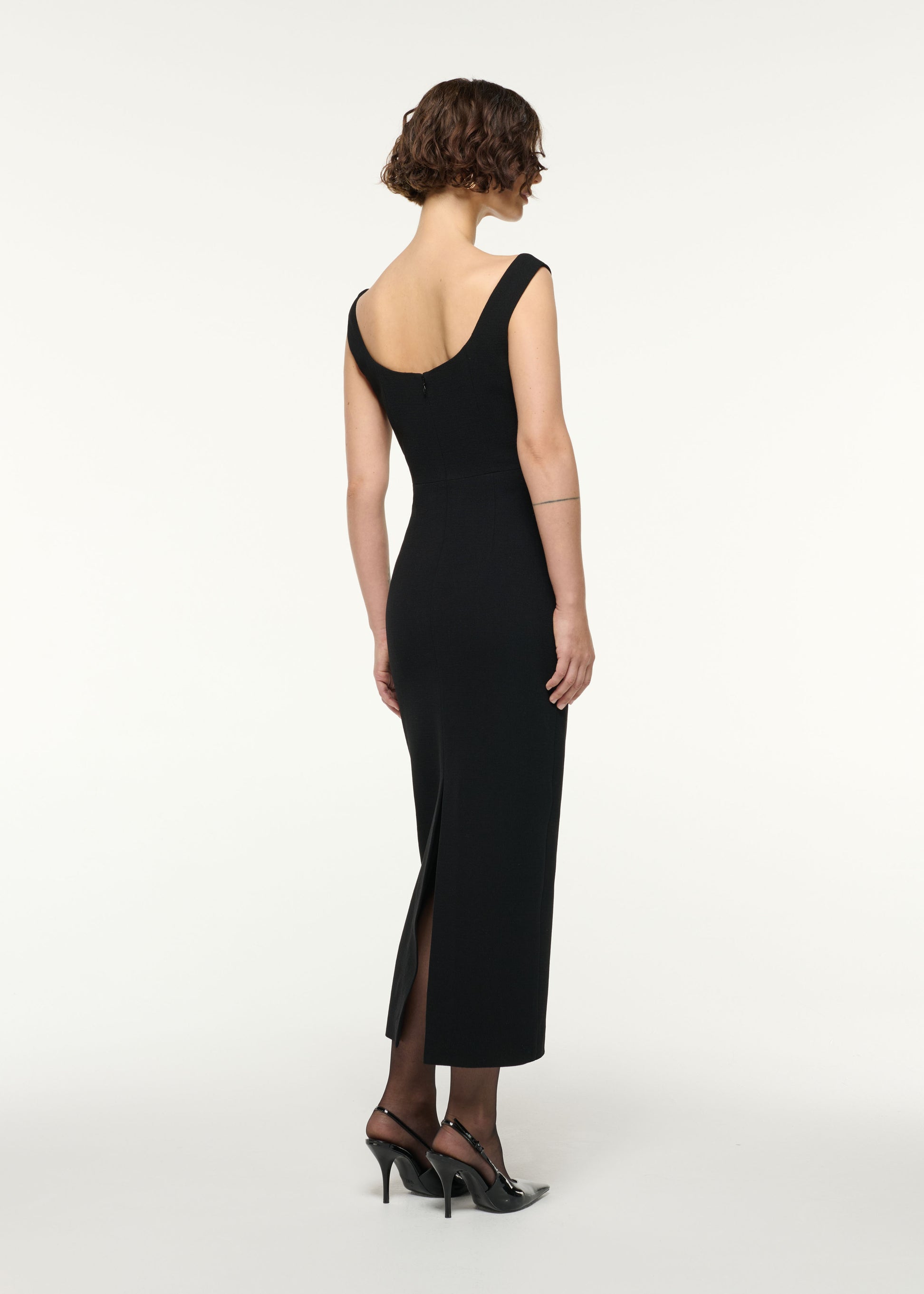 Back view of a model wearing the Scallop Lace Insert Wool Cocktail Dress in Black