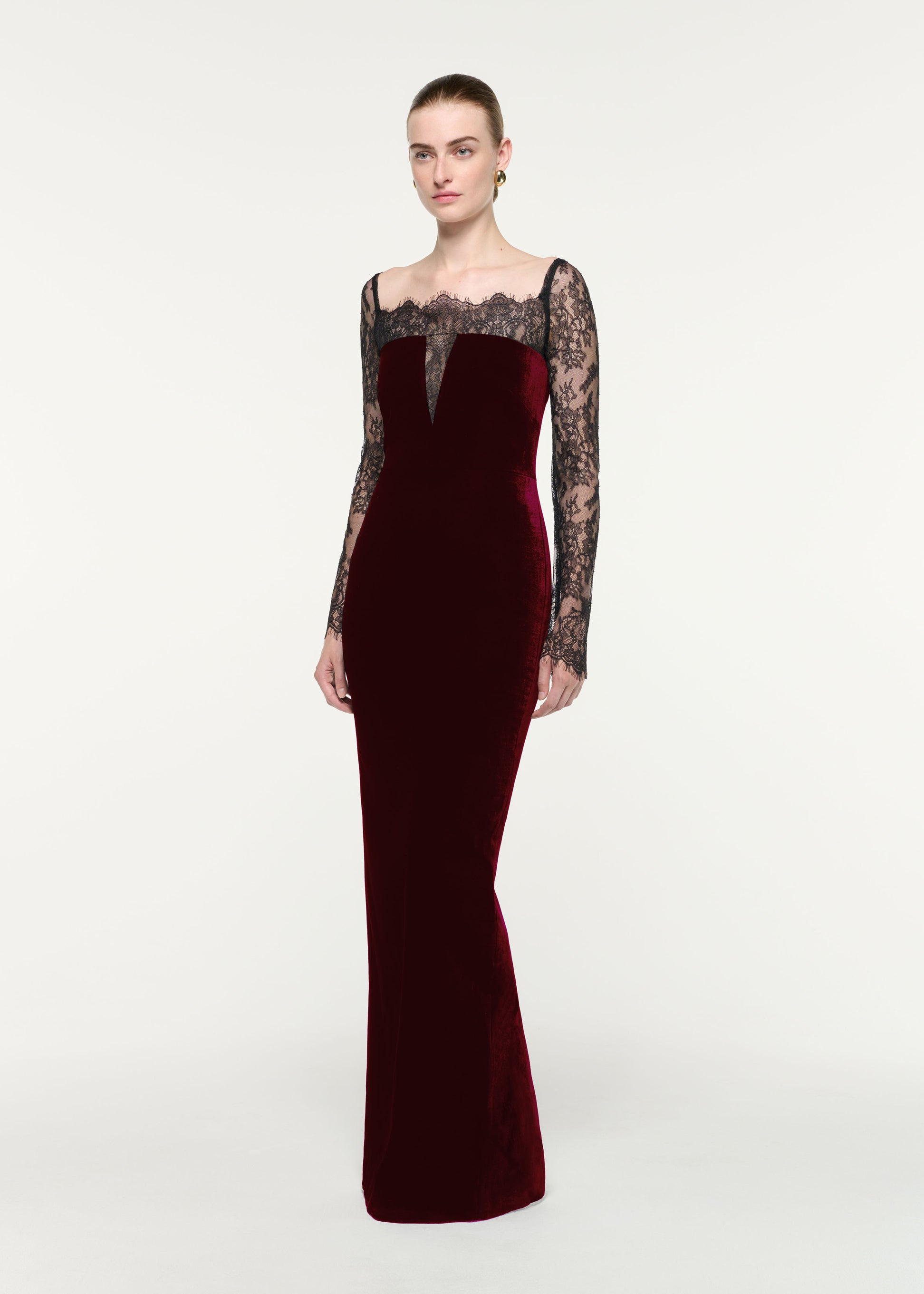 Side view of a model wearing the Scalloped Lace And Velvet Gown
