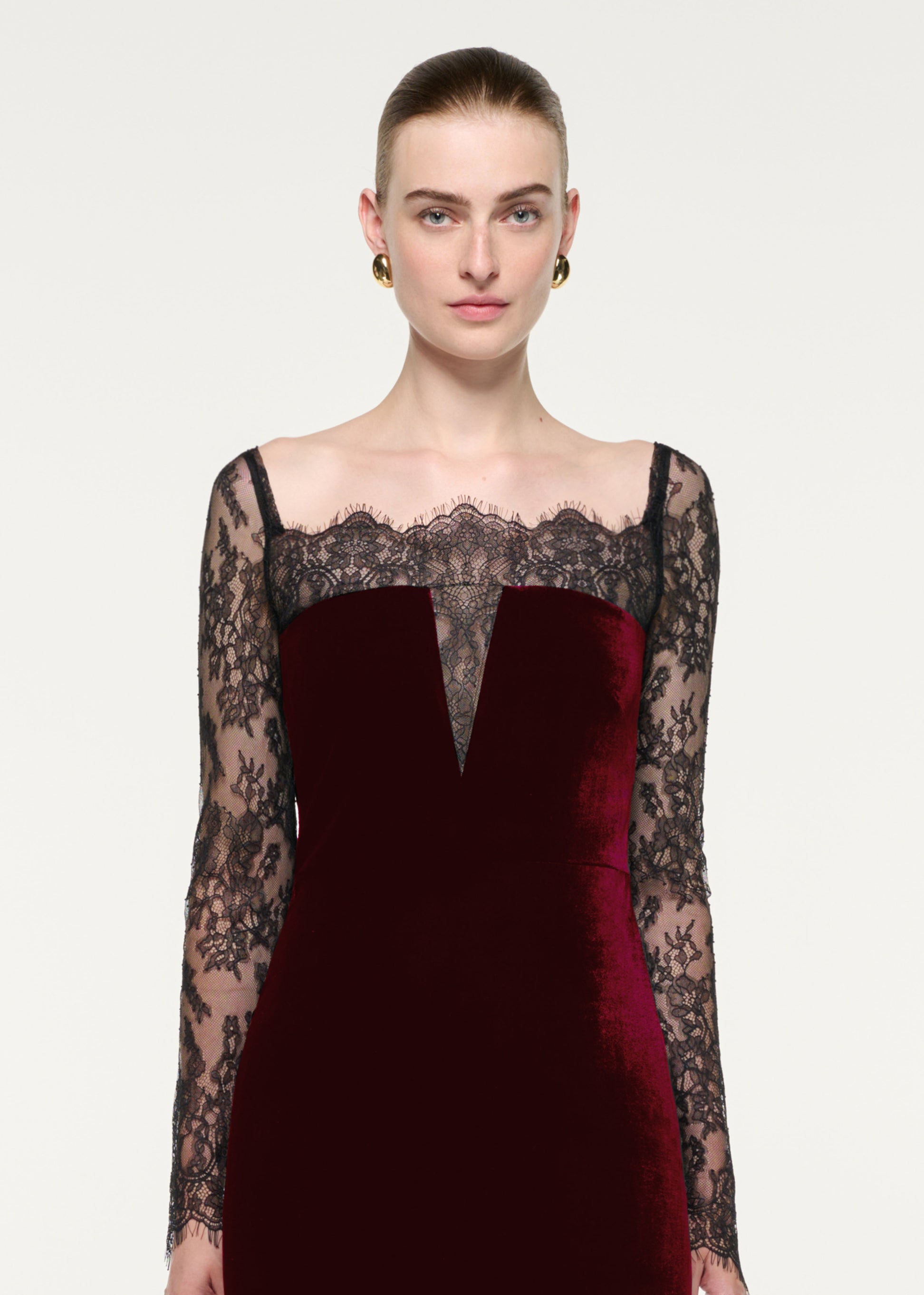 Close up of a model wearing the Scalloped Lace And Velvet Gown