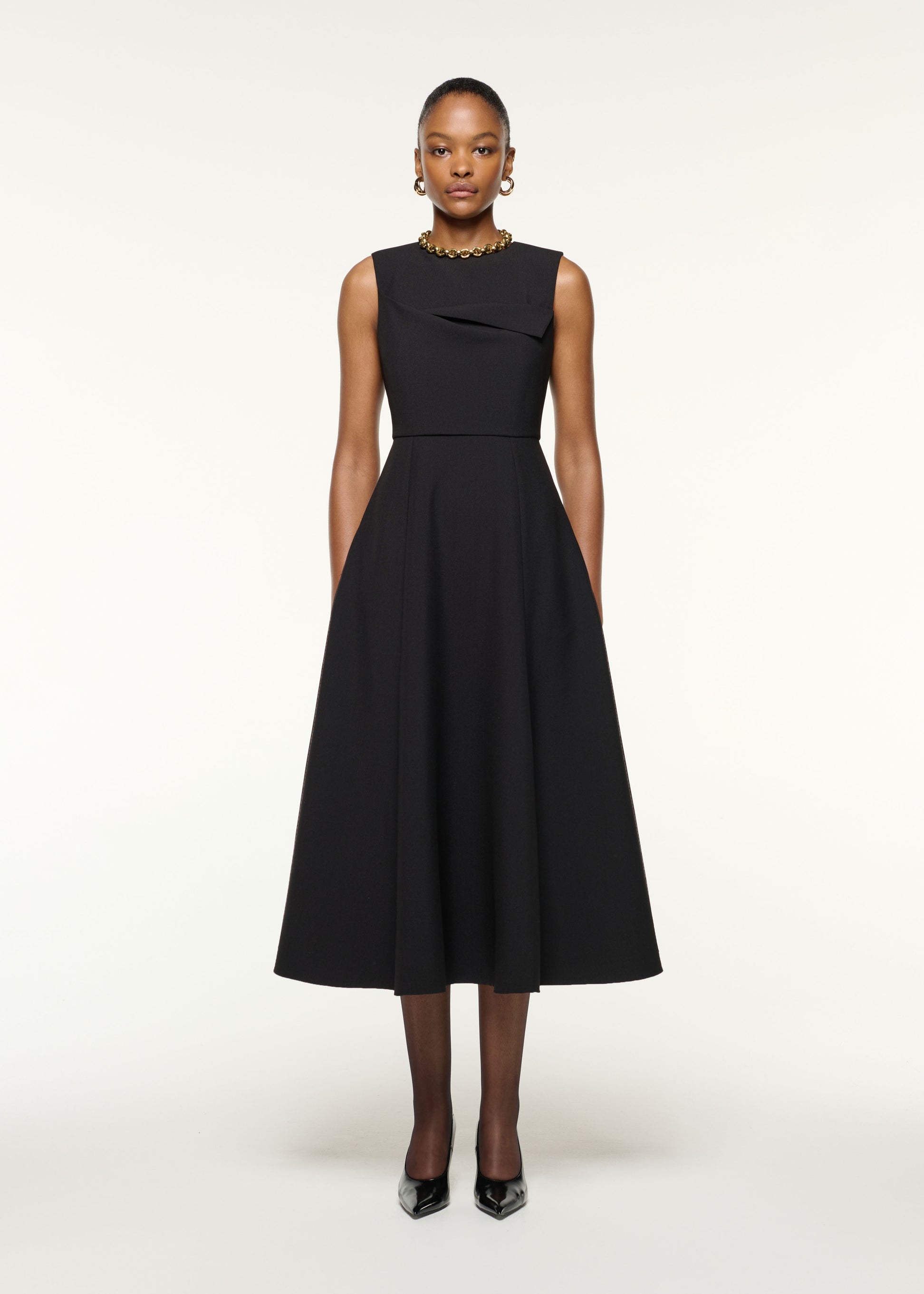 Front view of a model wearing the Origami Bust Line Flared Midi Dress in Black