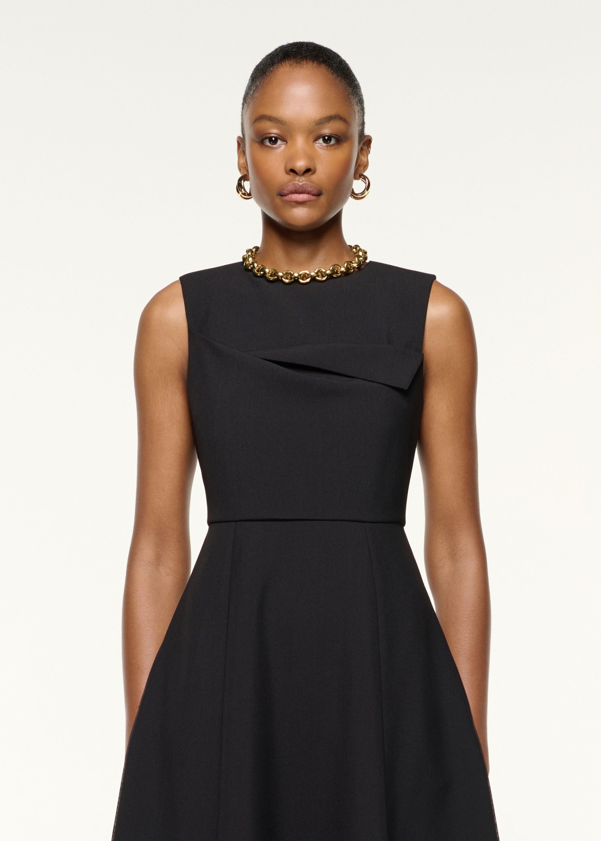 Close up of a model wearing the Origami Bust Line Flared Midi Dress in Black