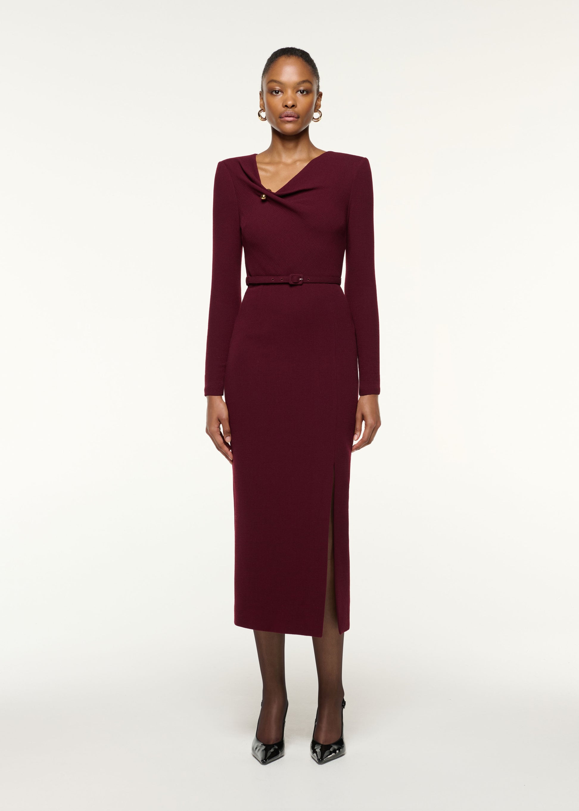 Front view of a model wearing the Asymmetrical Draped Neck Belted Wool Dress in Mulberry
