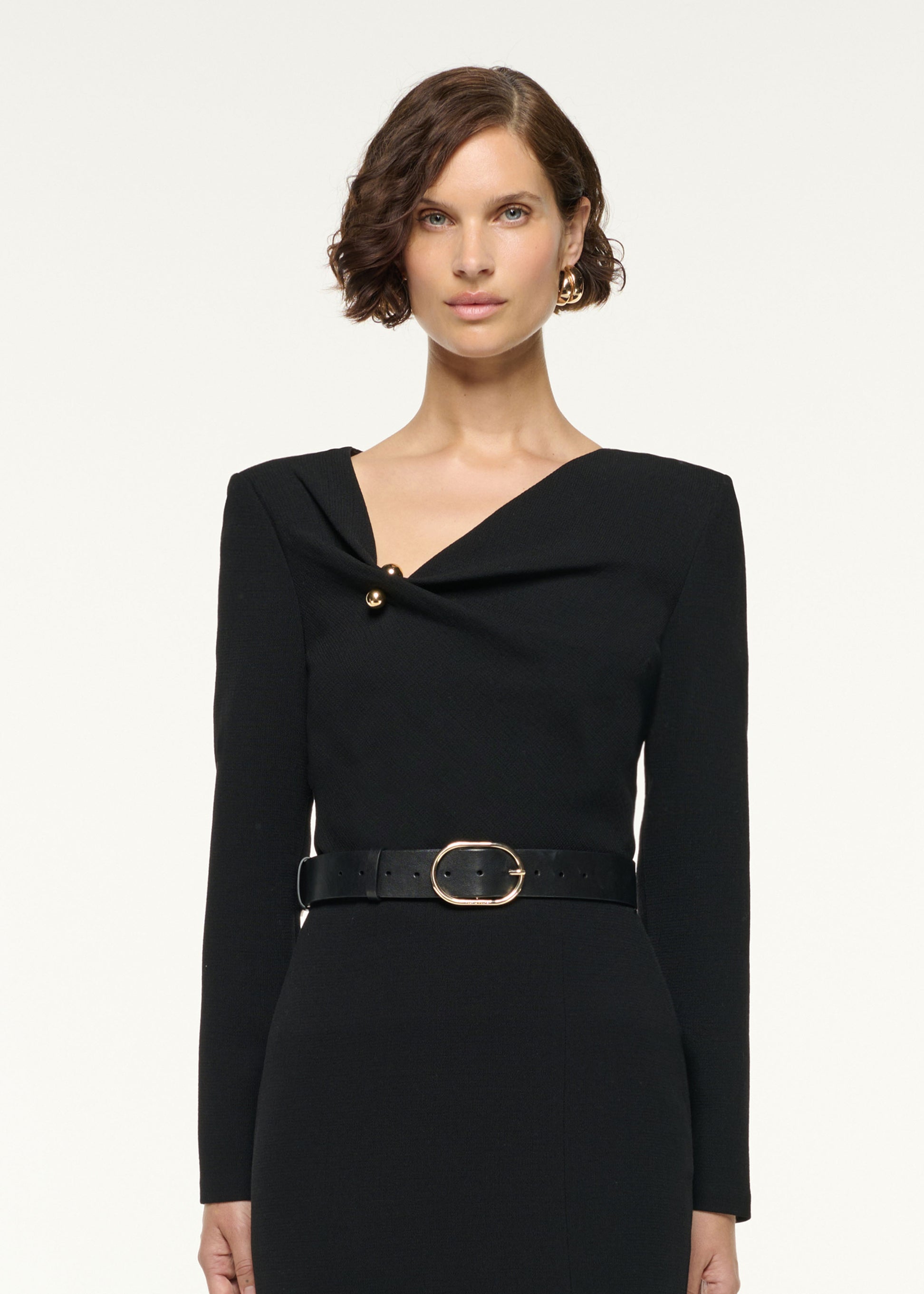 Close up of a model wearing the Asymmetrical Draped Neck Wool Top in Black