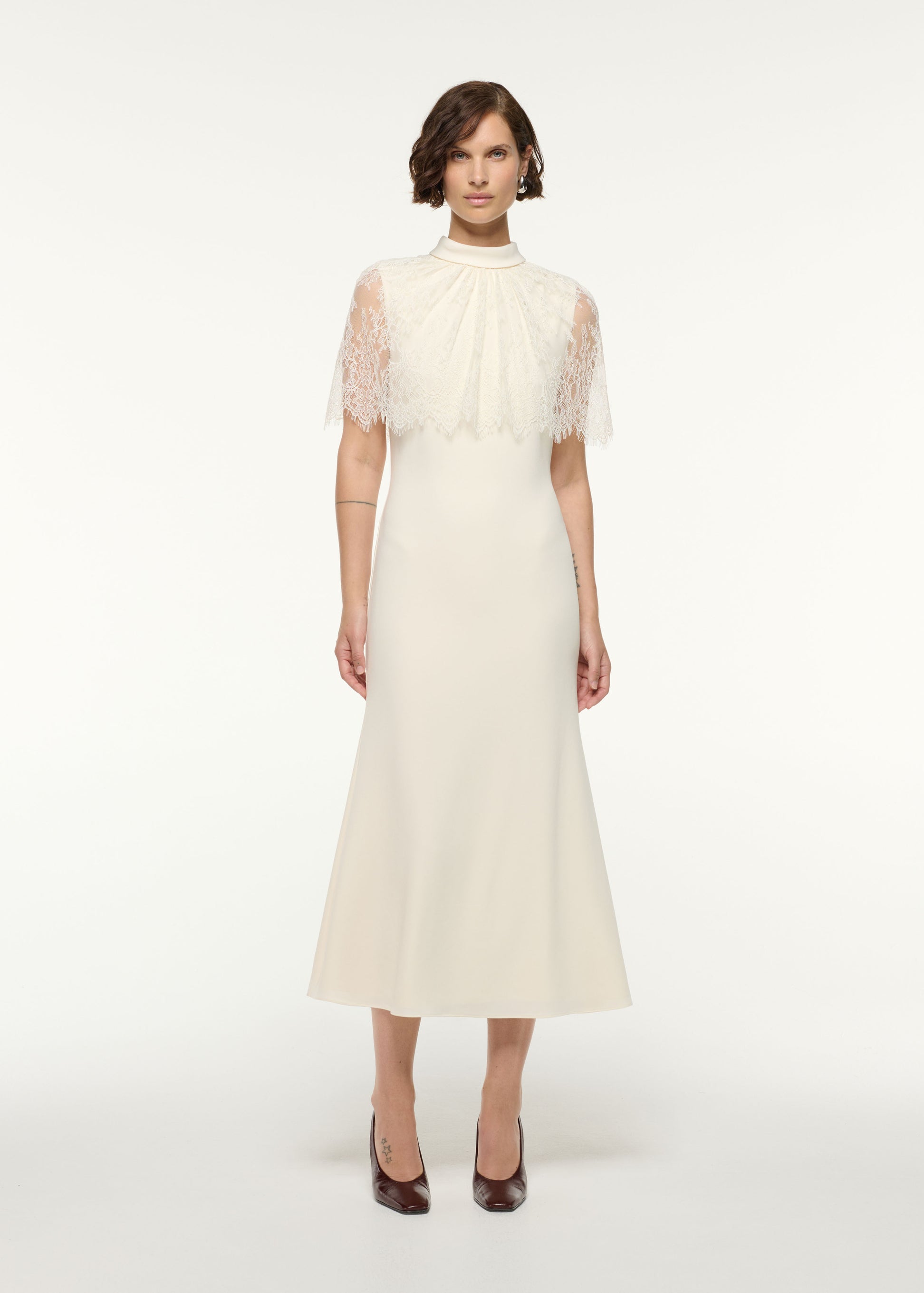 Front view of a model wearing the Scallop Lace Shawl Column Midi Dress in Cream