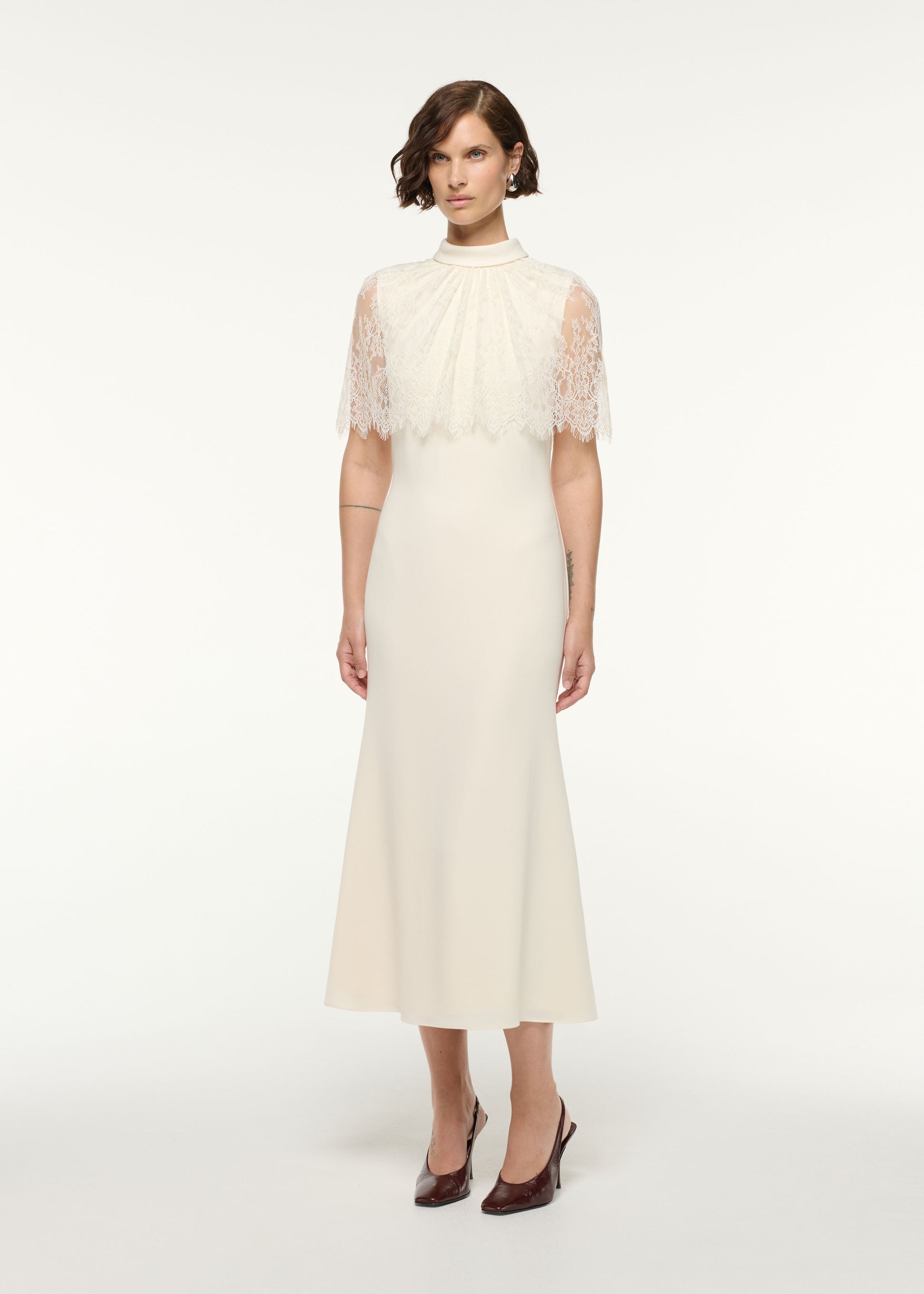 Side view of a model wearing the Scallop Lace Shawl Column Midi Dress in Cream