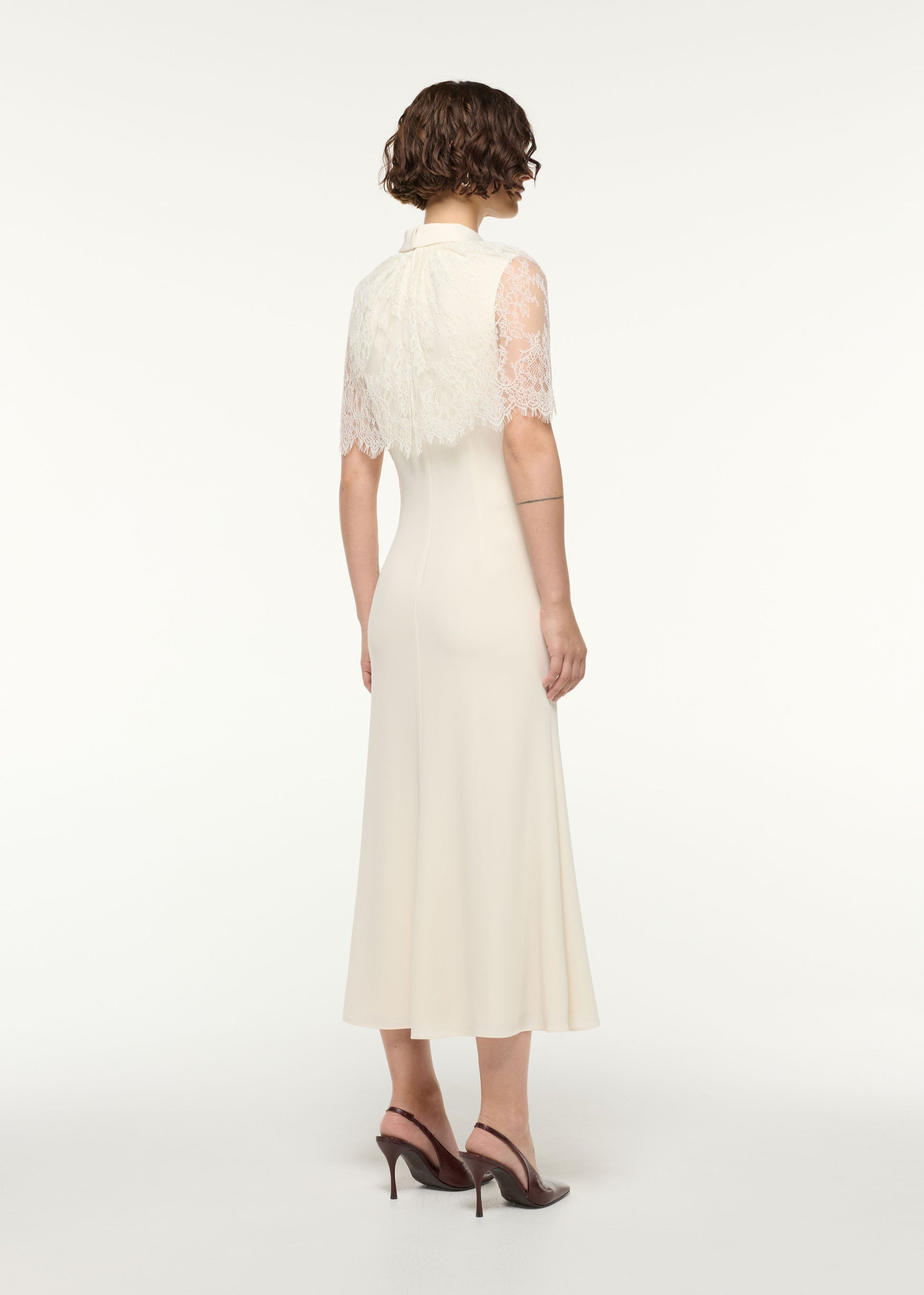 Back view of a model wearing the Scallop Lace Shawl Column Midi Dress in Cream