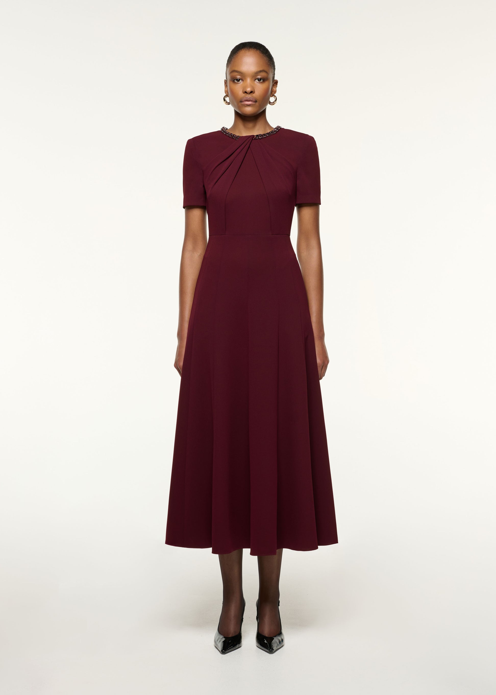 Front view of a model wearing the Twisted Drape Crystal Trim Neckline Dress in Mulberry