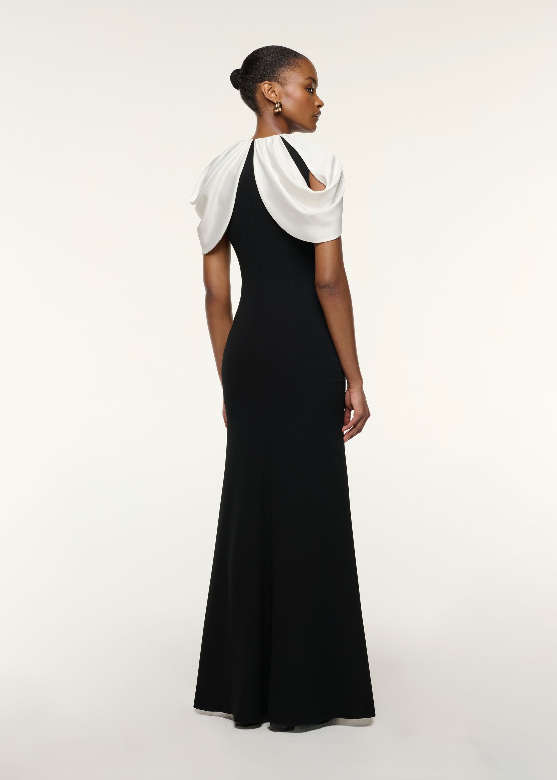 Back view of a model wearing the Gathered Shawl Crystal Trim Neckline Gown in Monochrome
