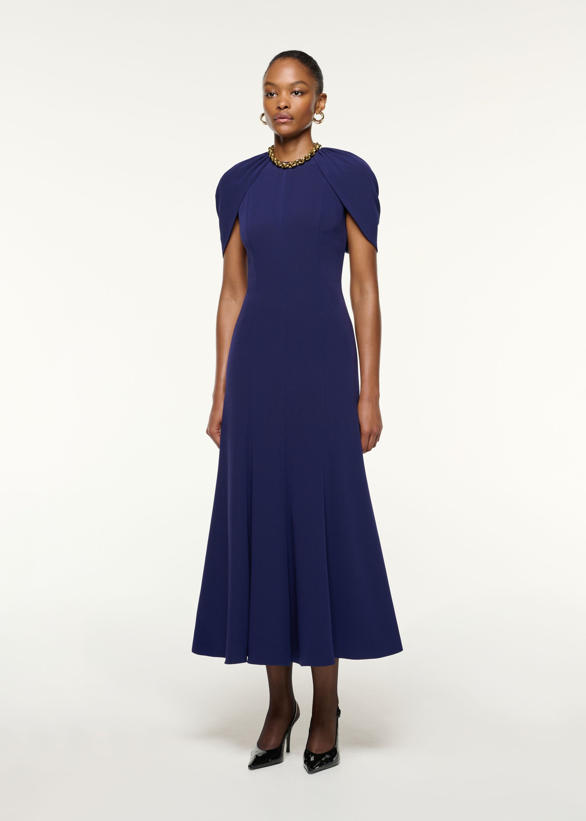 Side view of a model wearing the Gathered Shawl Satin Ceremony Dress in Navy