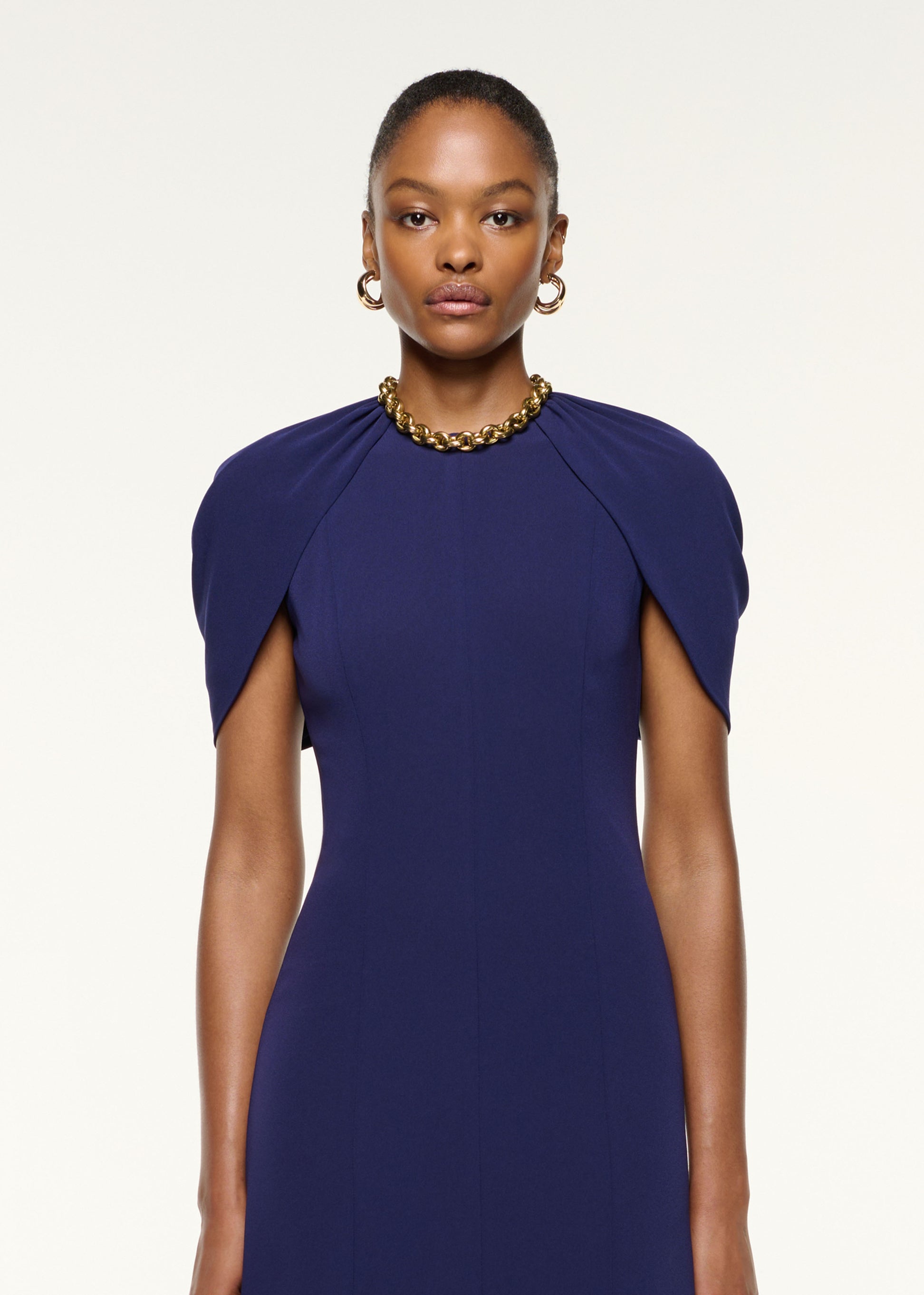 Close up of a model wearing the Gathered Shawl Satin Ceremony Dress in Navy