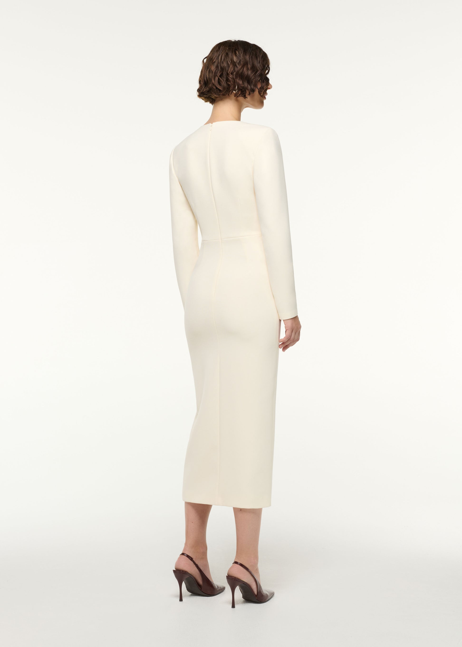 Back view of a model wearing the Flower Detail Cocktail Midi Dress in Cream