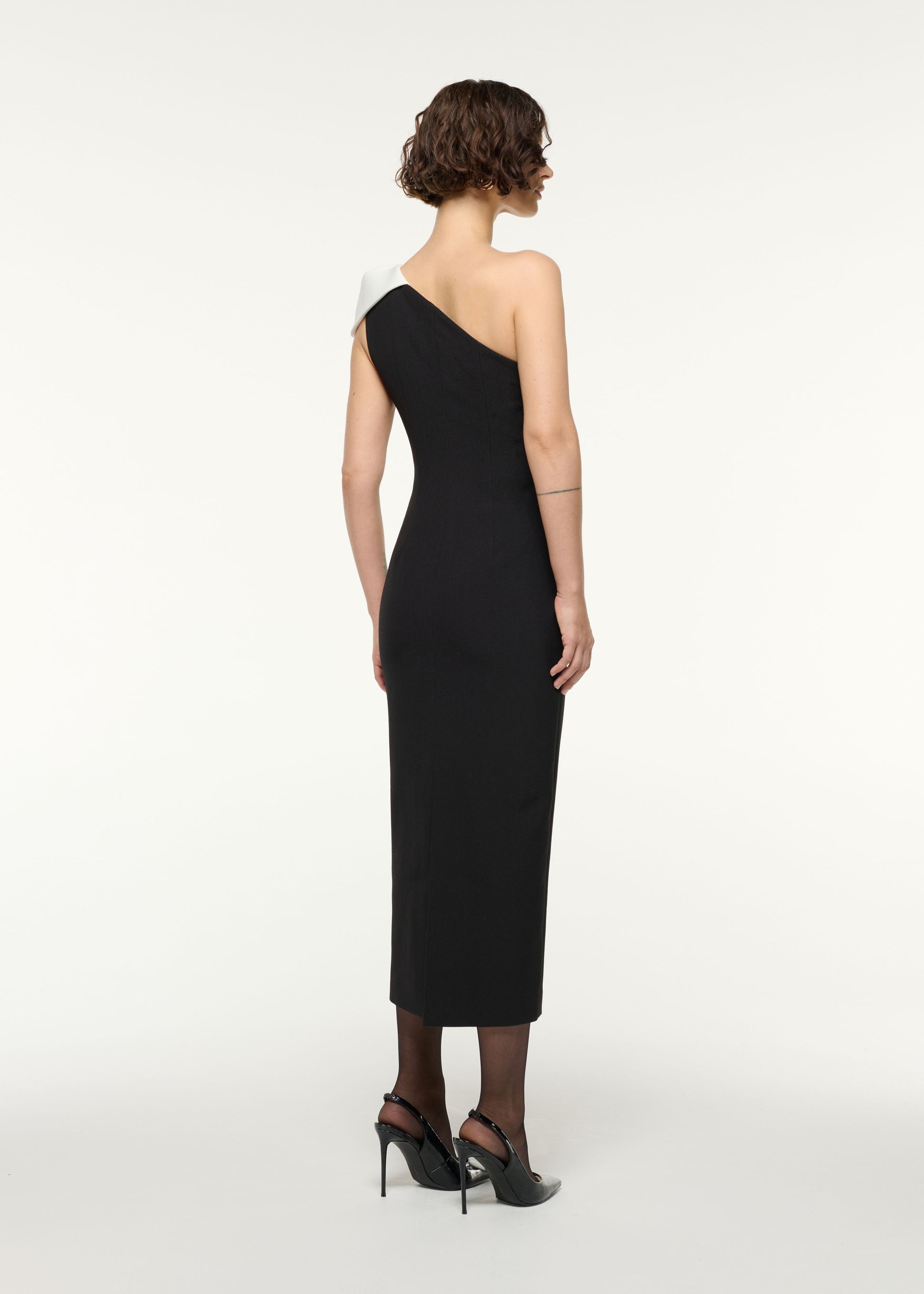 Back view of a model wearing the One Shoulder Monochrome Cocktail Dress in Monochrome