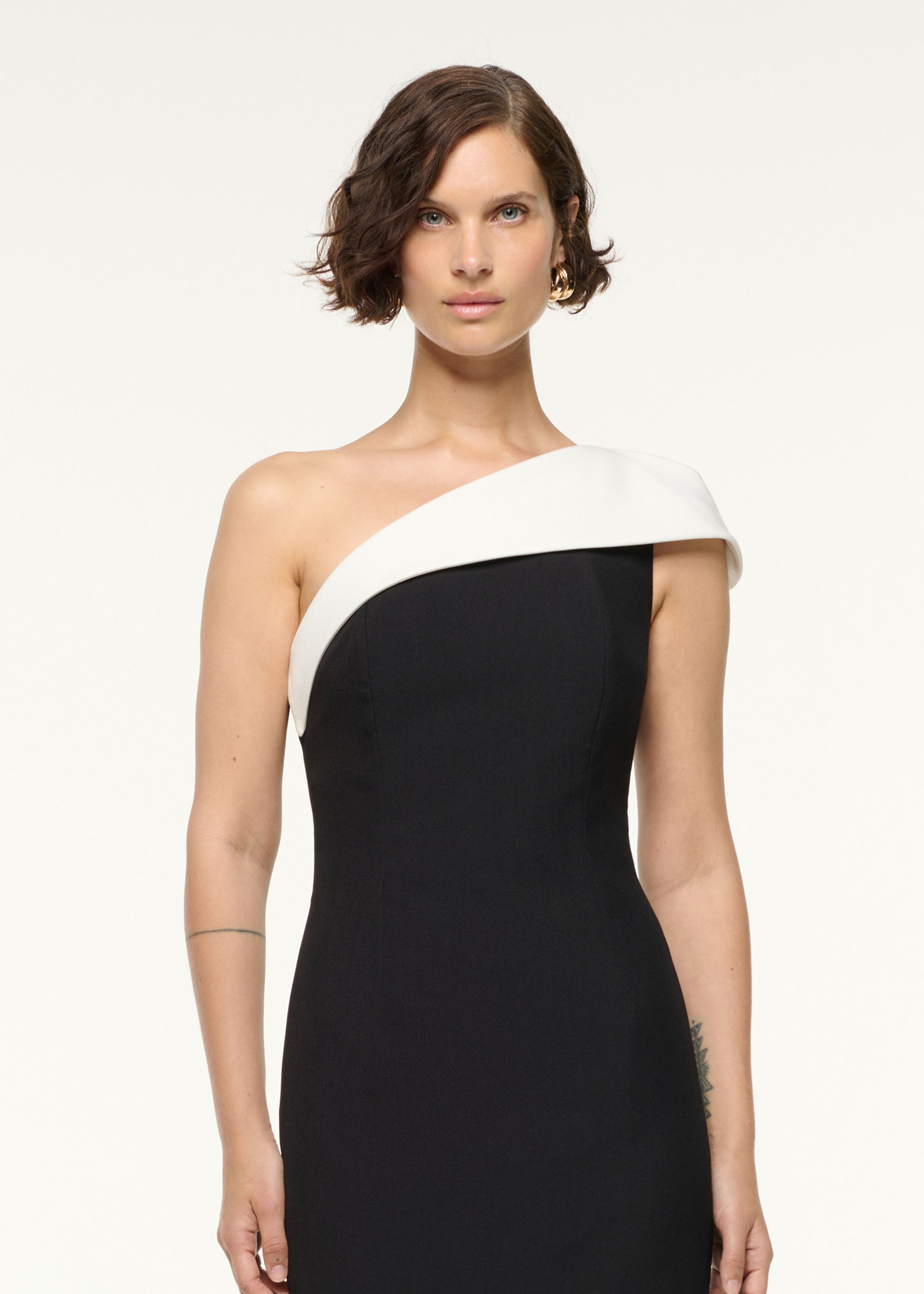 Close up of a model wearing the One Shoulder Monochrome Cocktail Dress in Monochrome