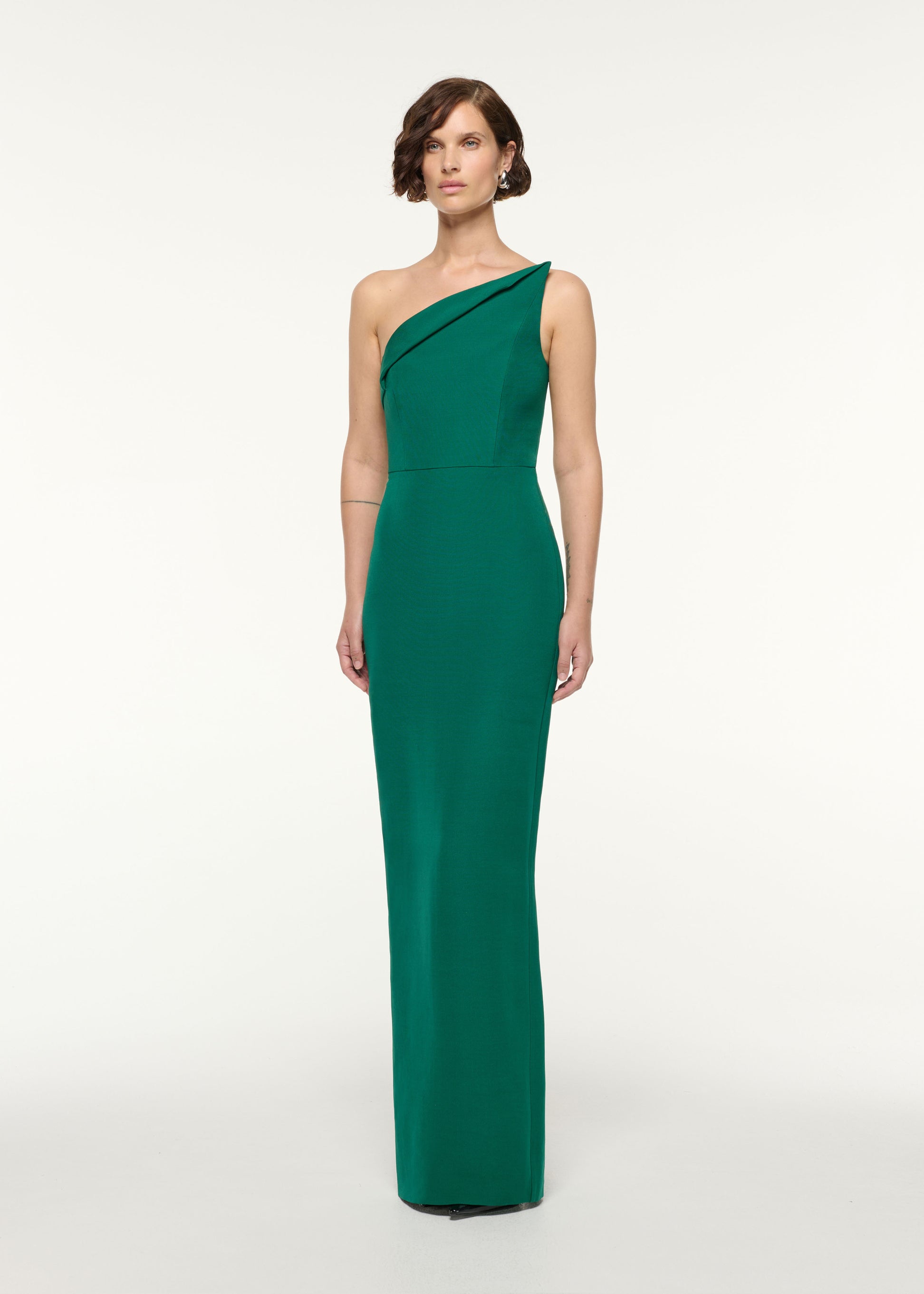 Side view of a model wearing the Asymmetrical Fold Wool Silk Gown in Green