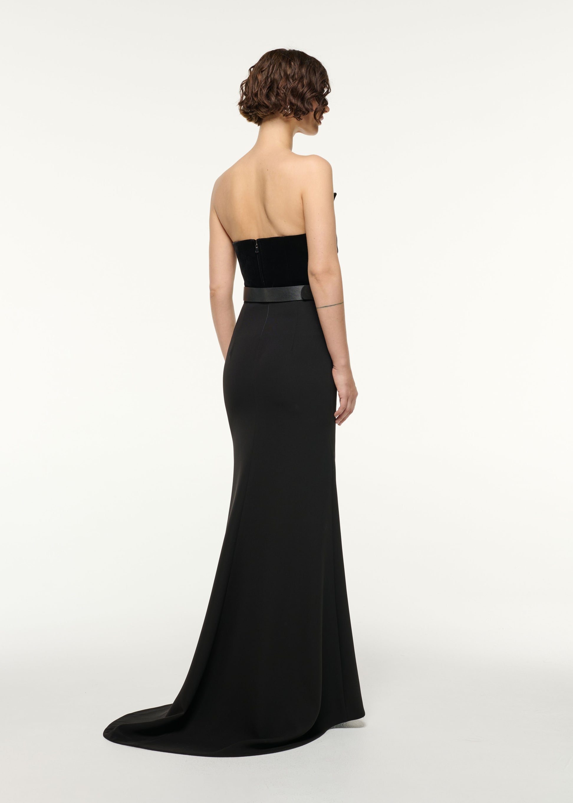 Back view of a model wearing the Structured Plunge Velvet Top in Black