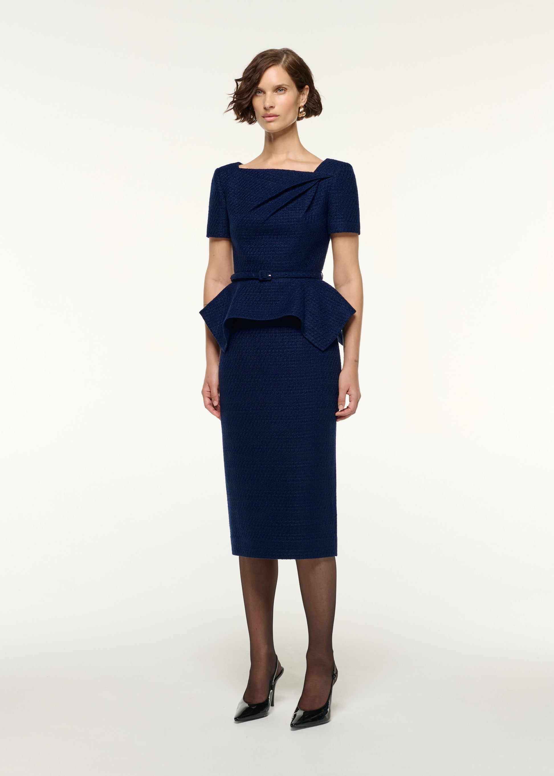 Side view of a model wearing the Boucle Column Midi Skirt in Navy