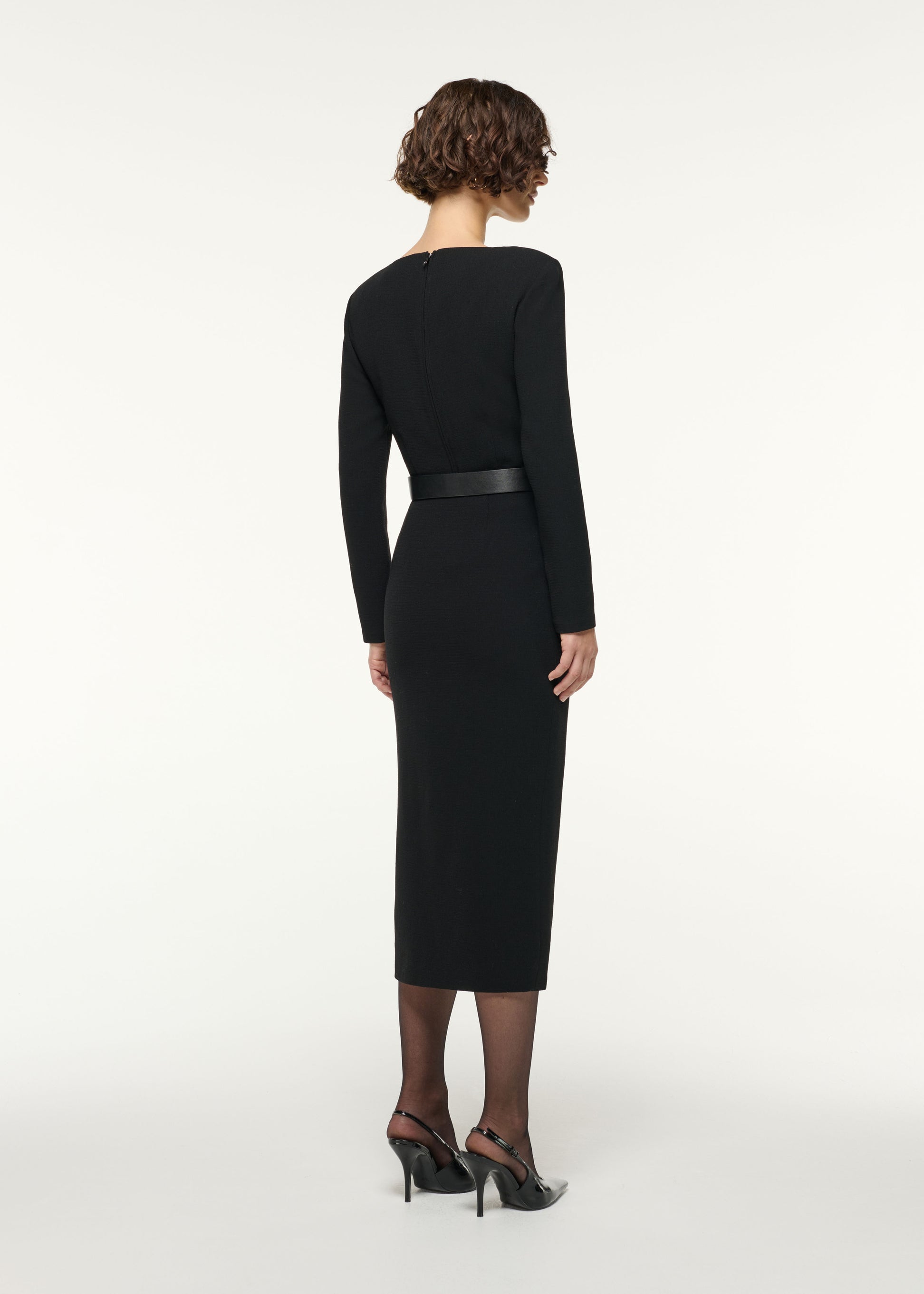 Back view of a model wearing the Scallop Lace Split Insert Wool Skirt in Black