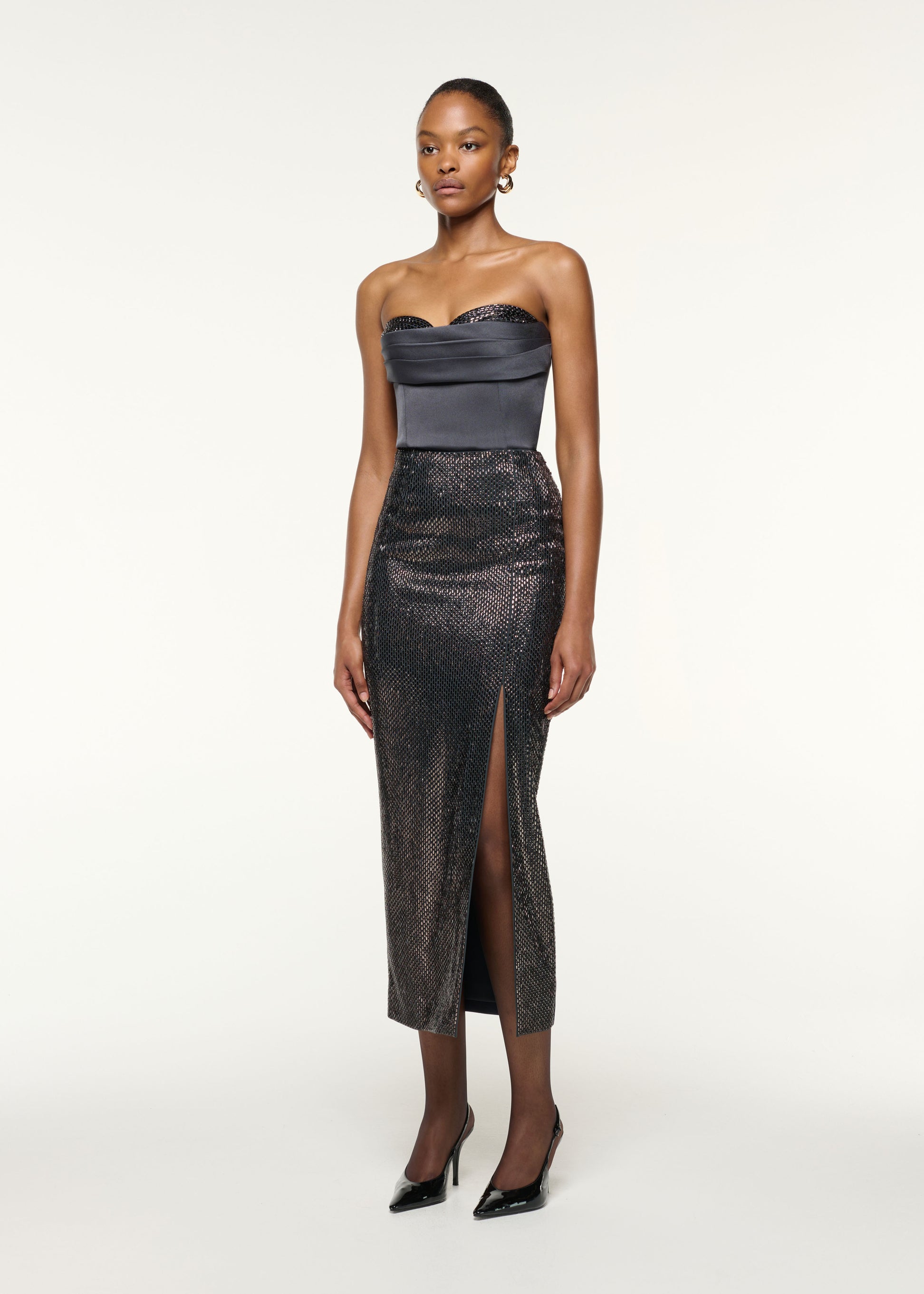 Side view of a model wearing the Diamante Crepe Split Maxi Skirt in Grey