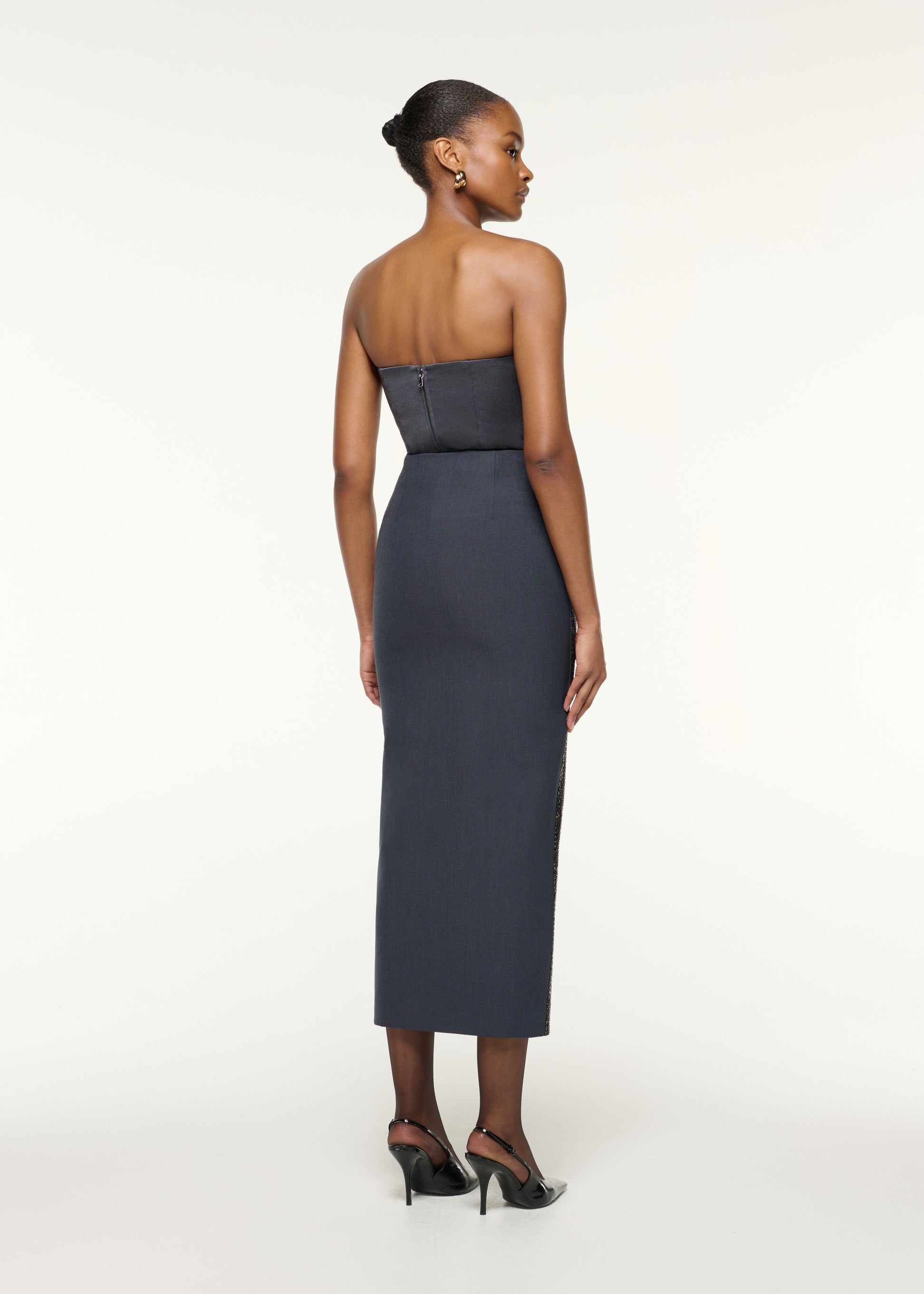 Back view of a model wearing the Diamante Crepe Split Maxi Skirt in Grey