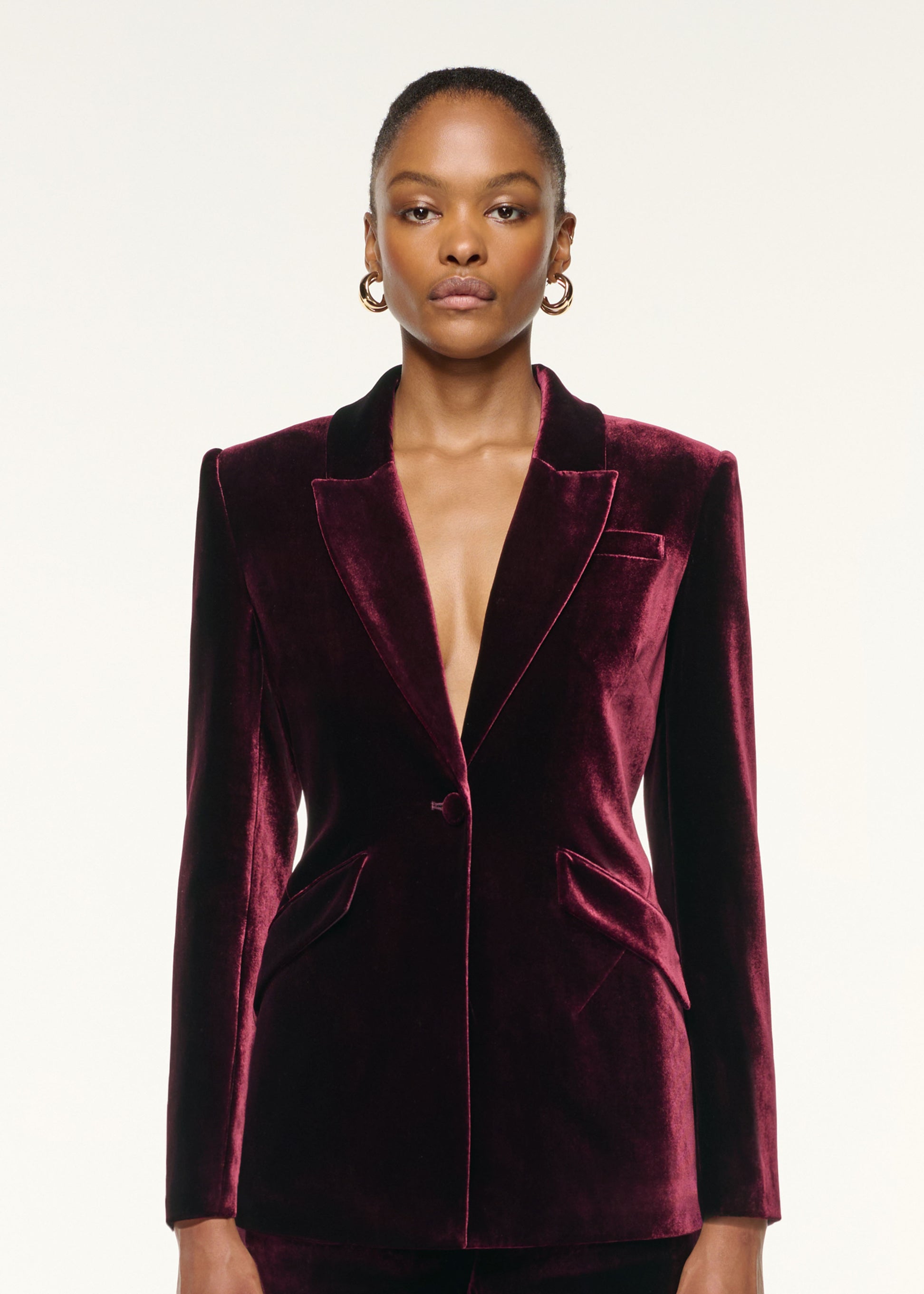 Close up of a model wearing the Tailored Velvet Jacket in Mulberry