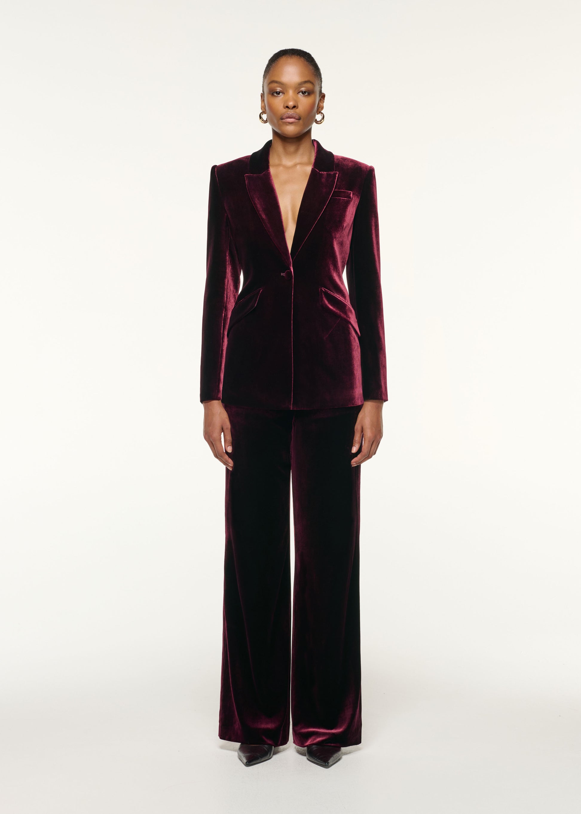 Front view of a model wearing the Tailored Velvet Wide Leg Trouser in Mulberry