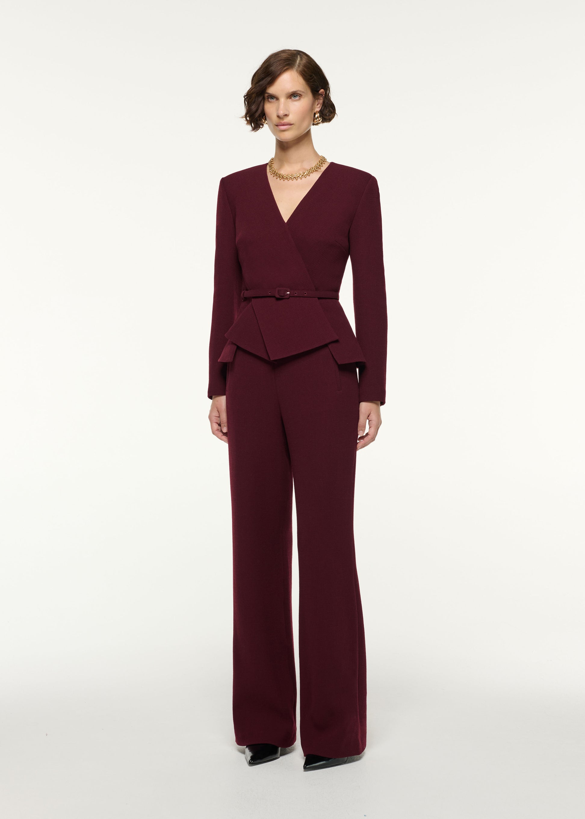 Side view of a model wearing the Tailored Wool Wide Leg Trouser in Mulberry