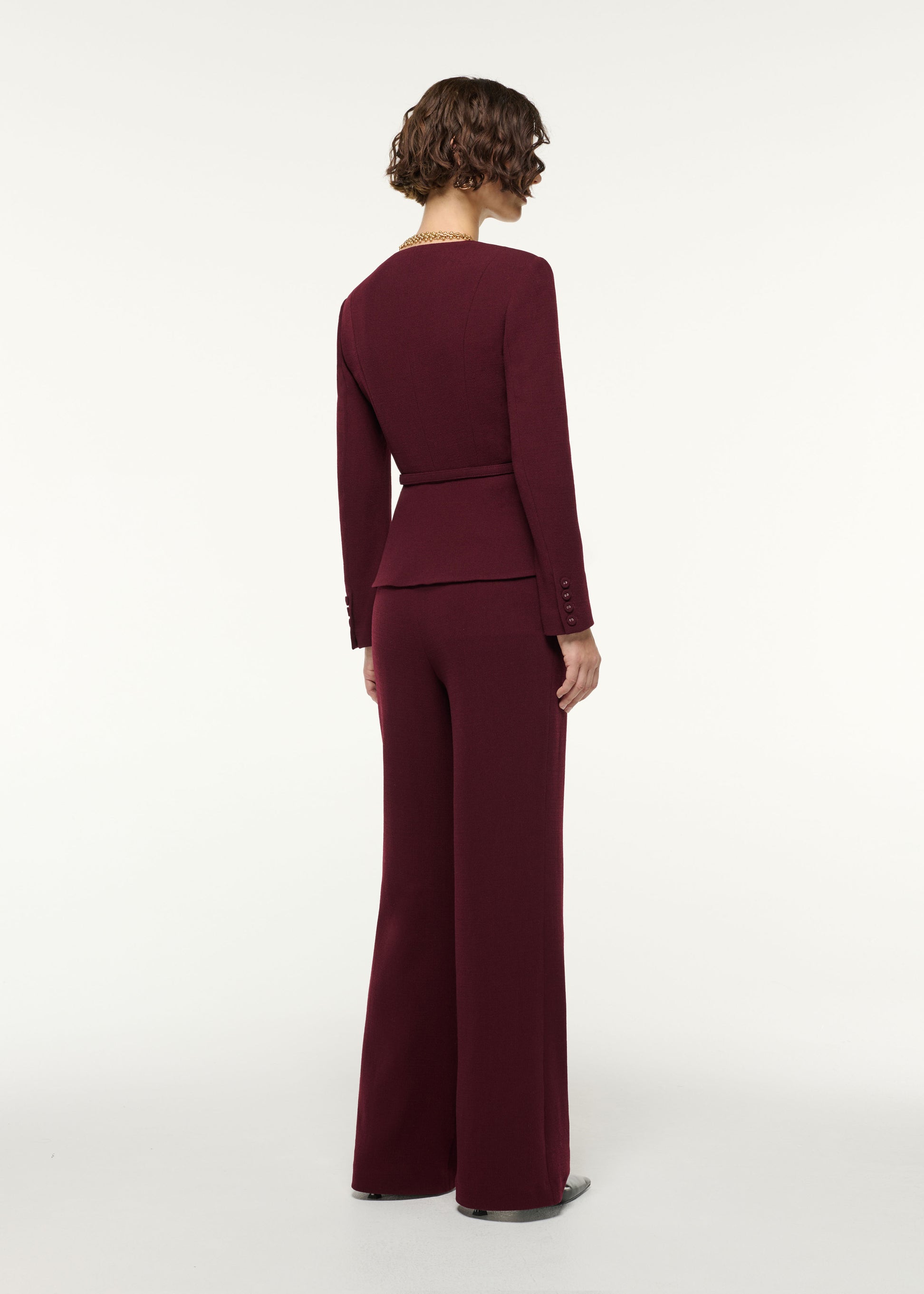 Back view of a model wearing the Tailored Wool Wide Leg Trouser in Mulberry