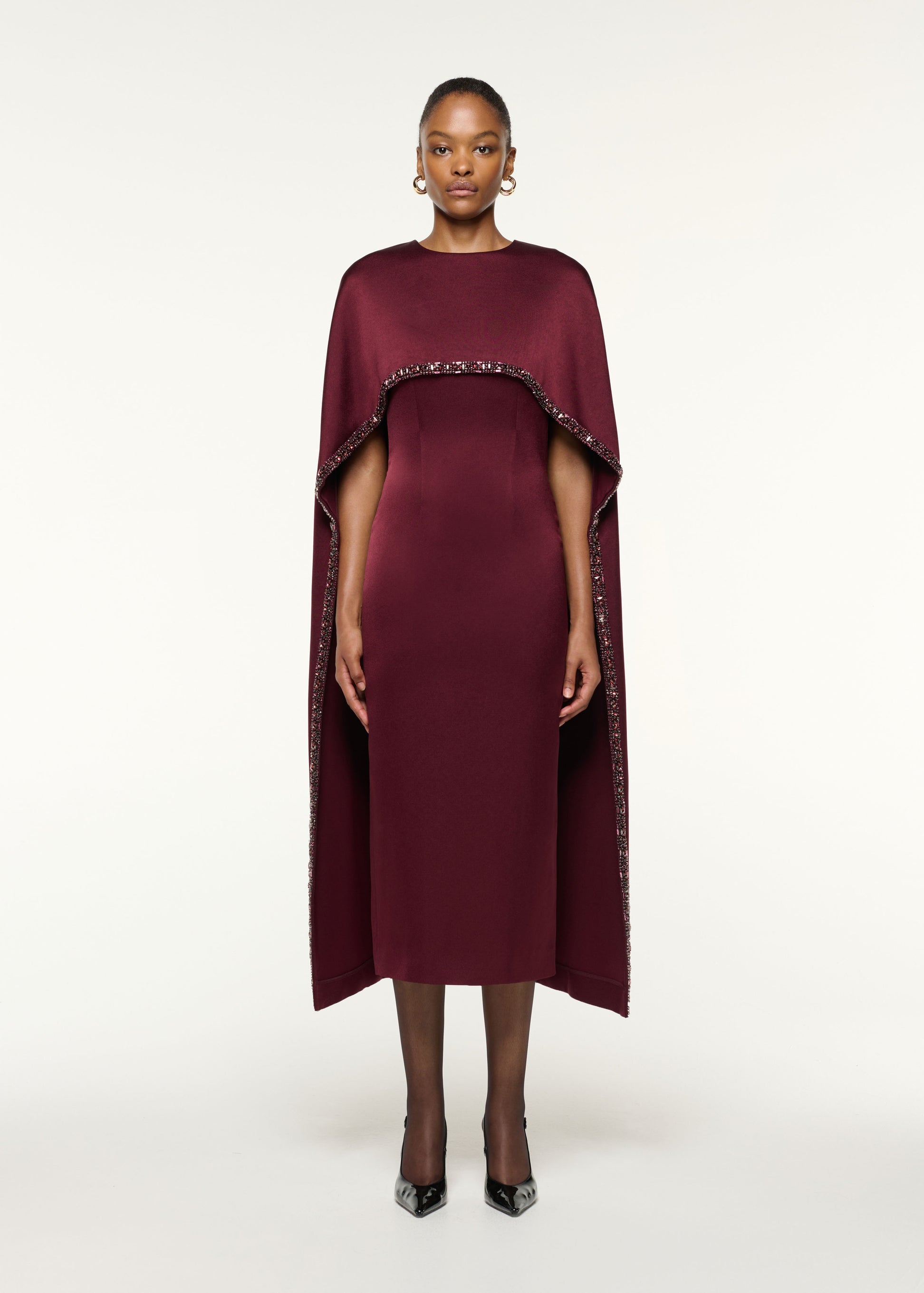 Front view of a model wearing the Crystal Trimmed Cape Midi Dress in Mulberry