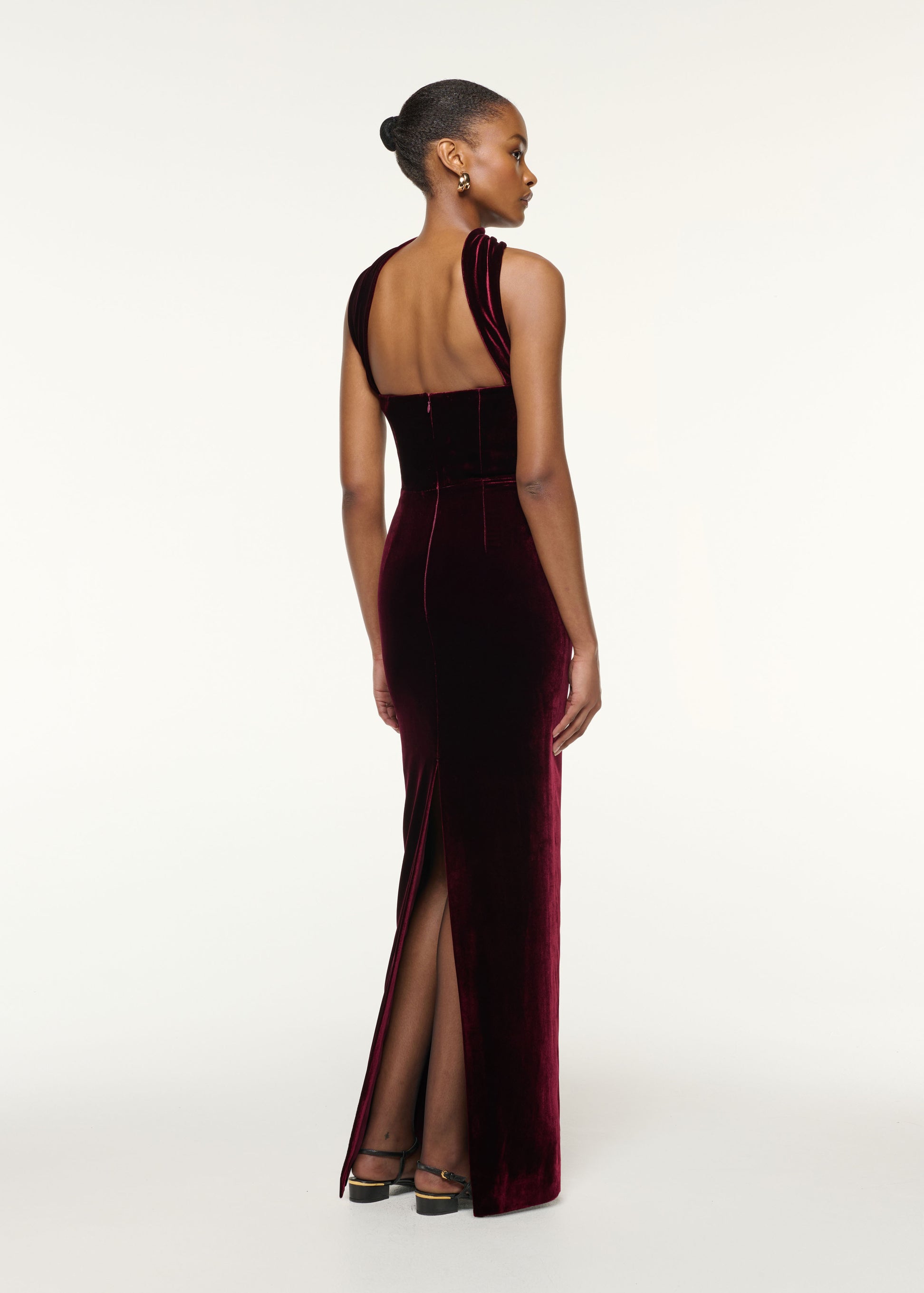 Back view of a model wearing the Scarf Detail Velvet Moon Gown in Mulberry