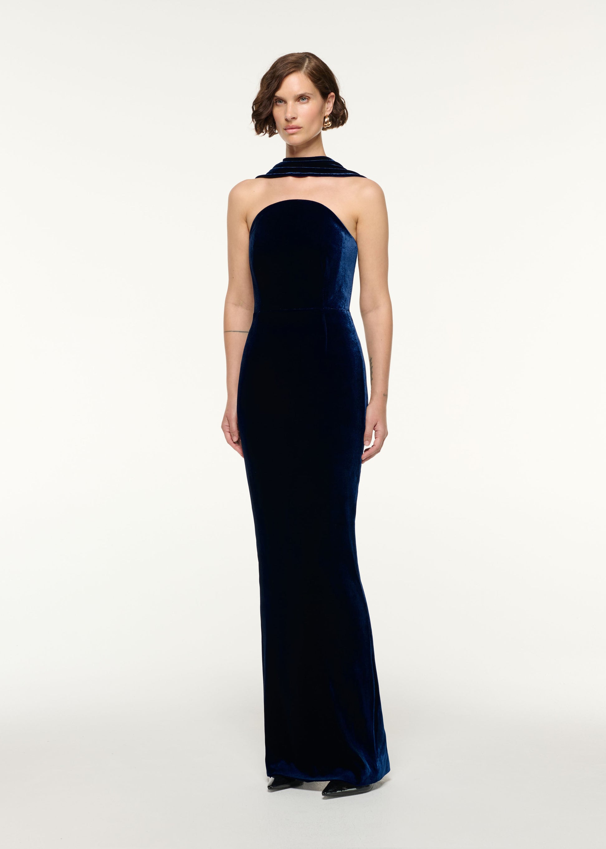 Side view of a model wearing the Scarf Neckline Velvet Moon Gown in Navy