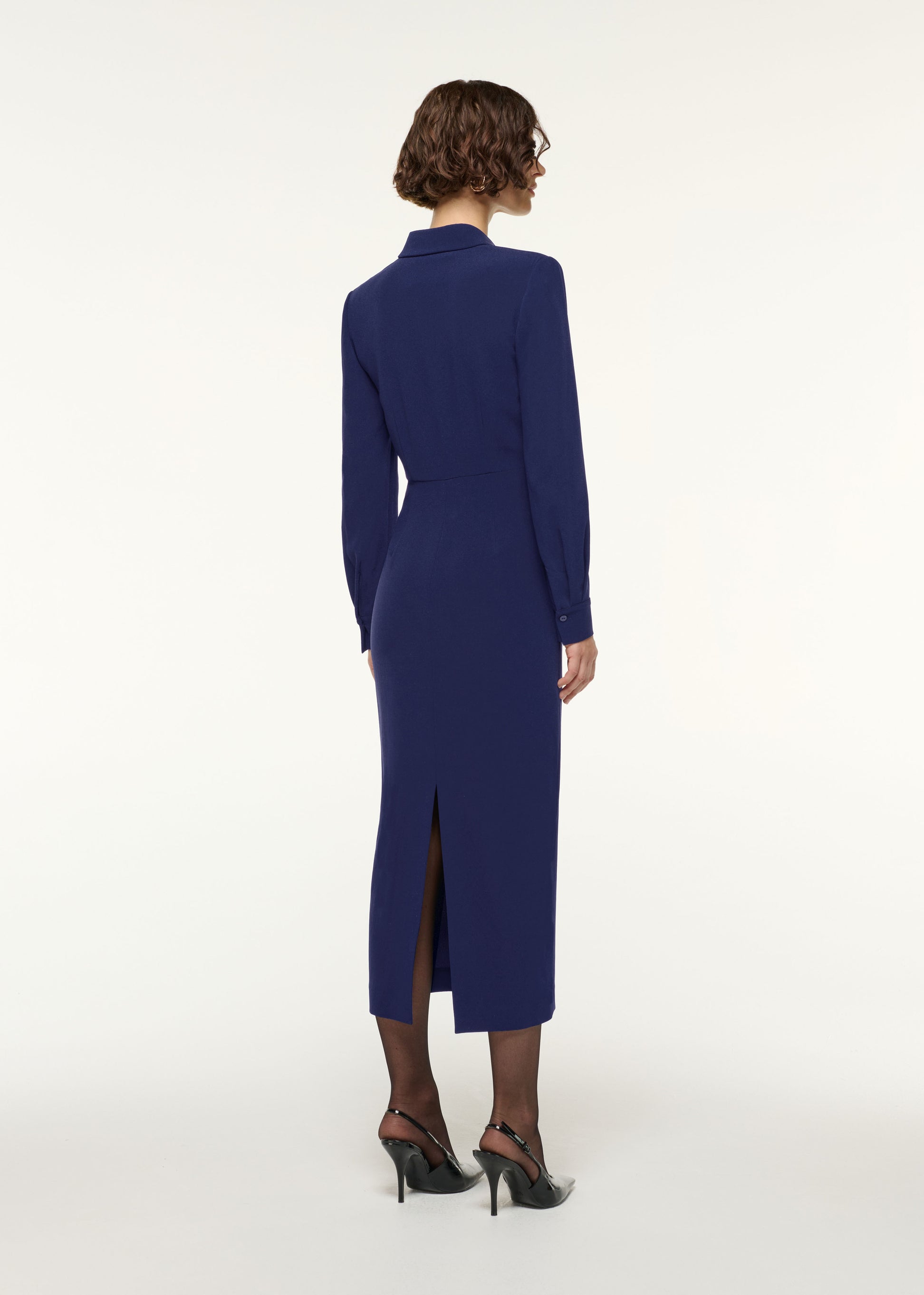 Back view of a model wearing the Gathered Drape Hip Midi Dress in Navy