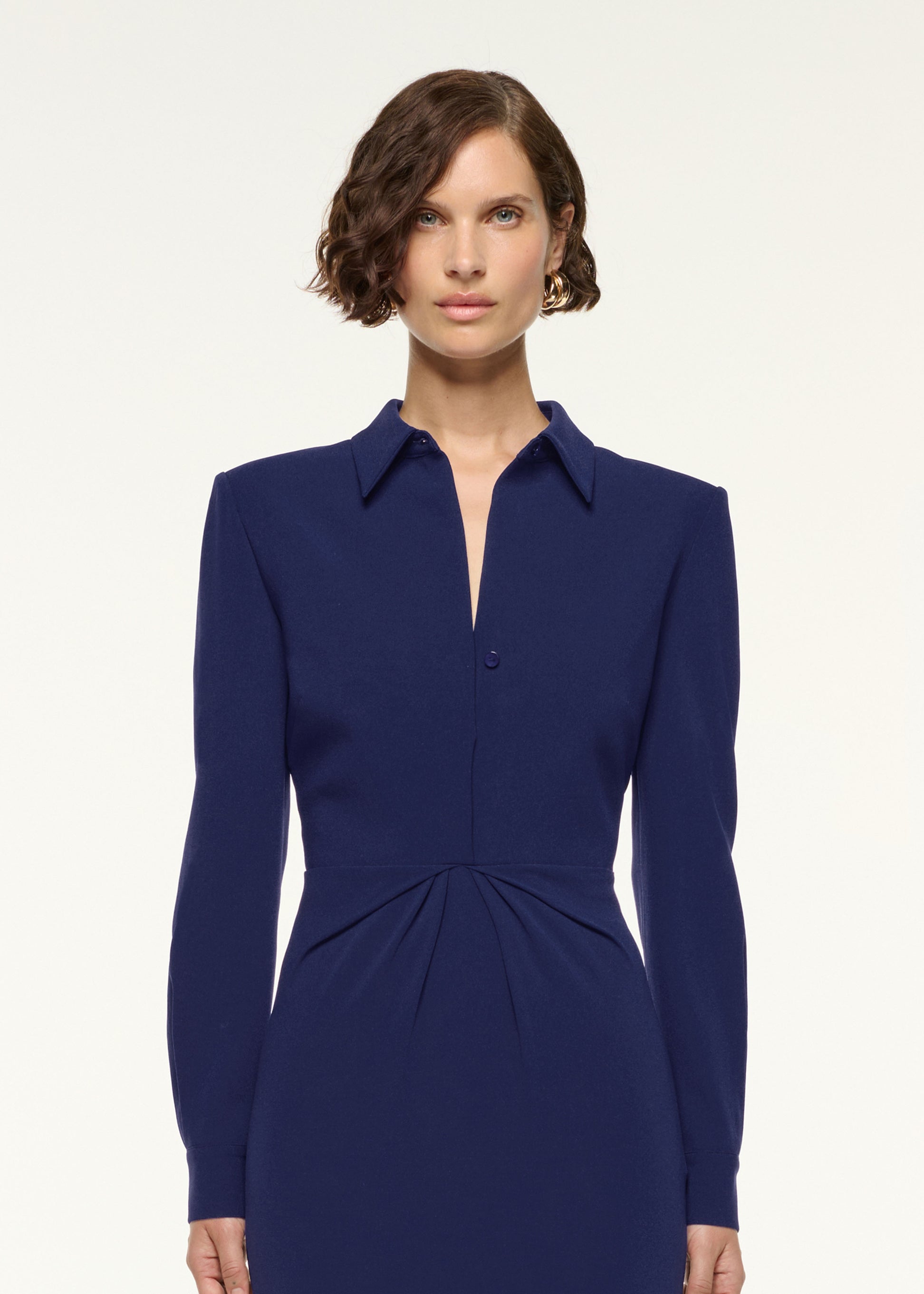 Close up of a model wearing the Gathered Drape Hip Midi Dress in Navy