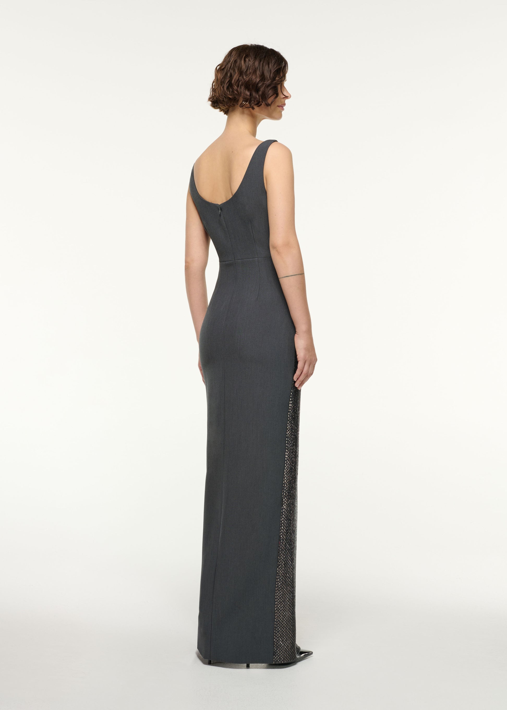 Back view of a model wearing the Drape Neckline Diamante Gown in Grey