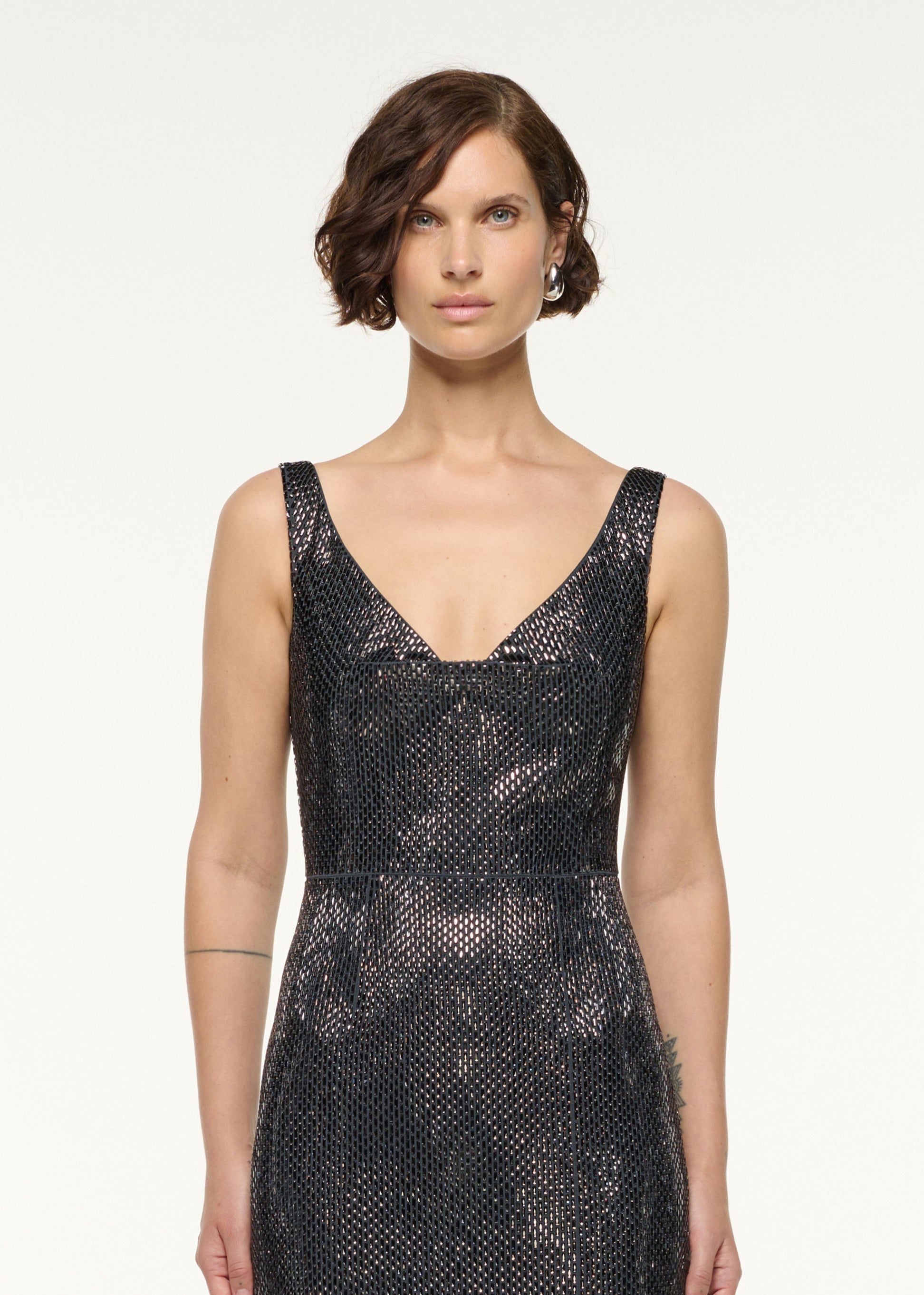 Close up of a model wearing the Drape Neckline Diamante Gown in Grey