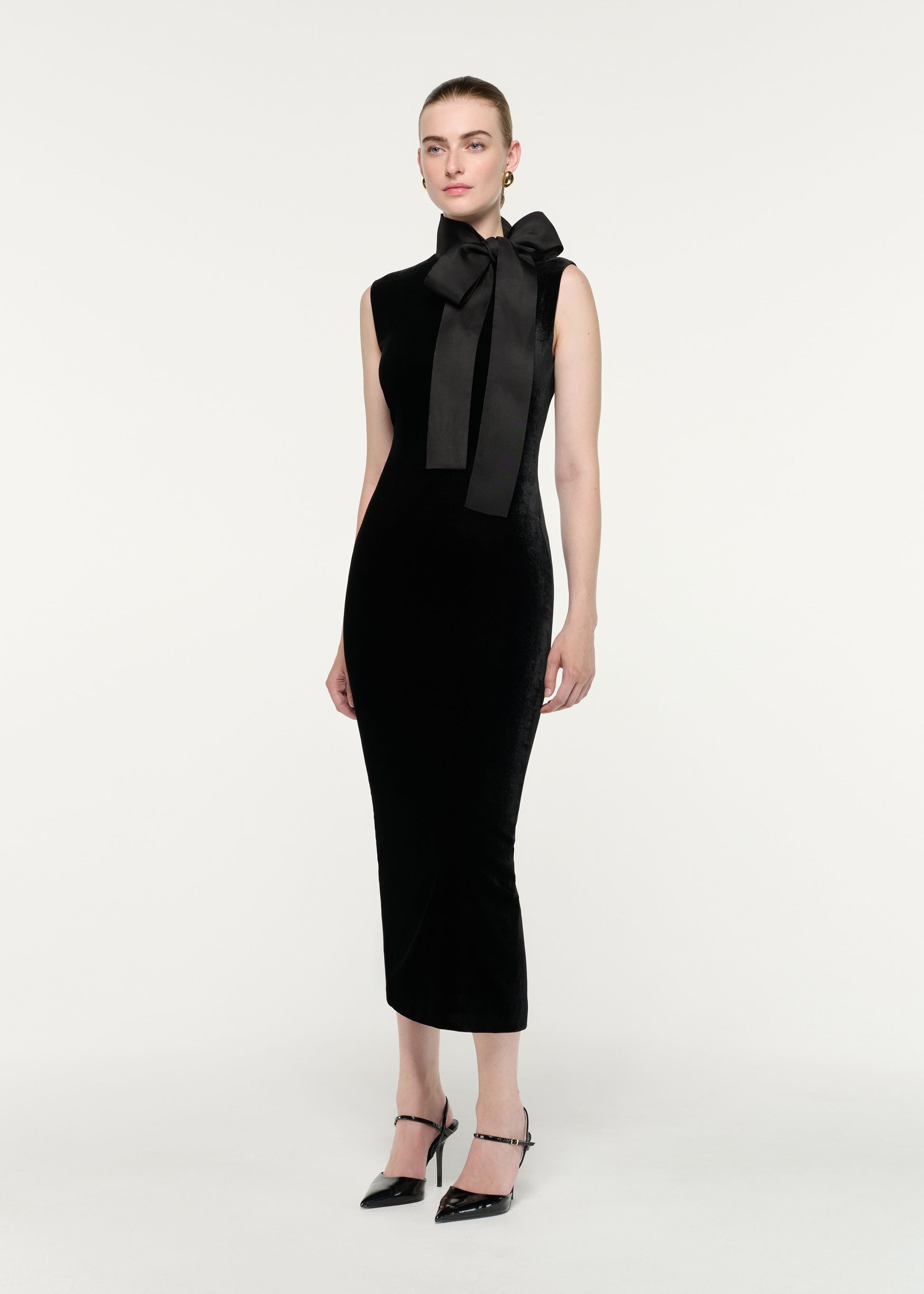 Side view of a model wearing the Velvet Midi Dress With Organza Bow Neck Tie