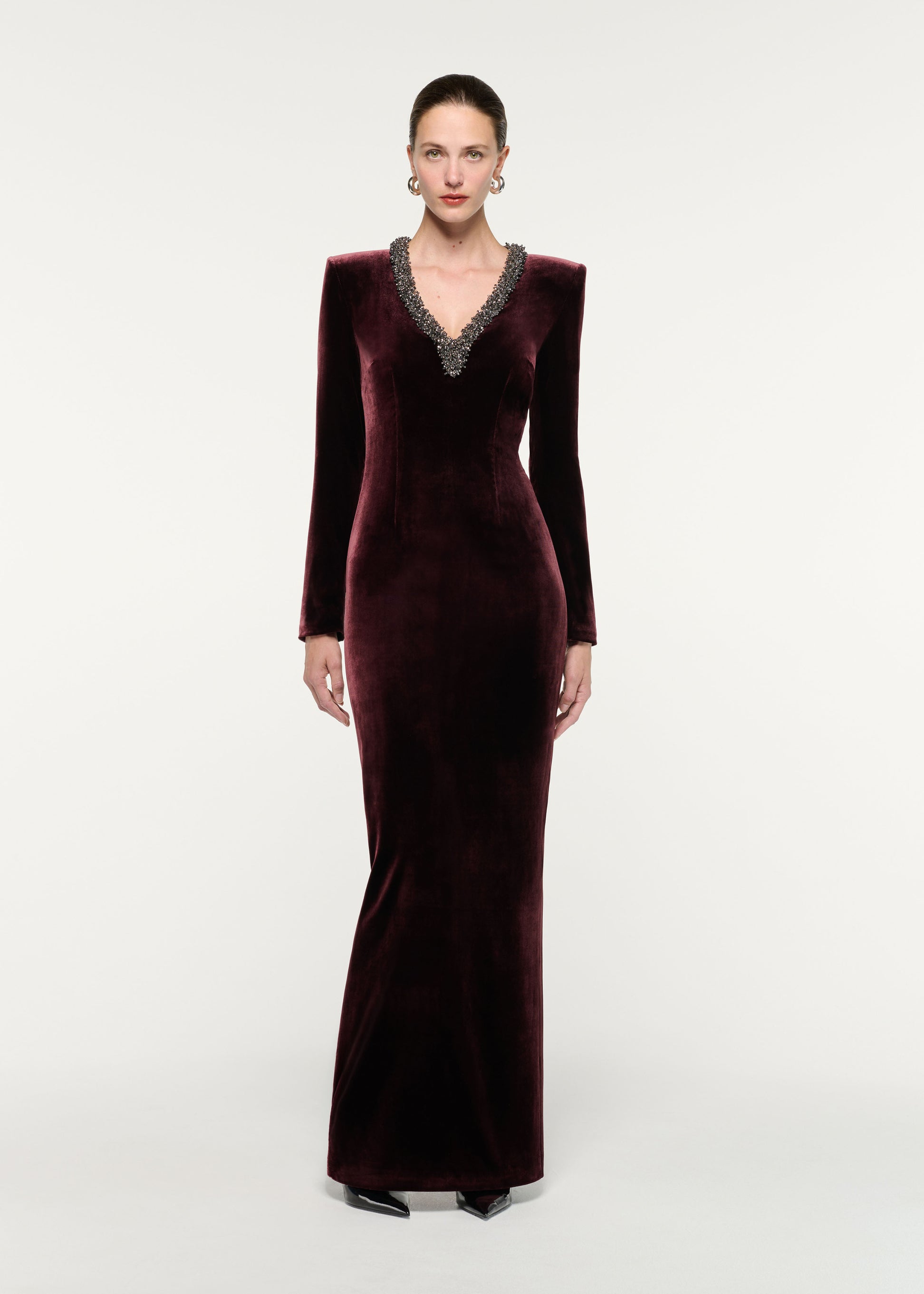 Front view of a model wearing the Long Sleeve Embellished Velvet Gown
