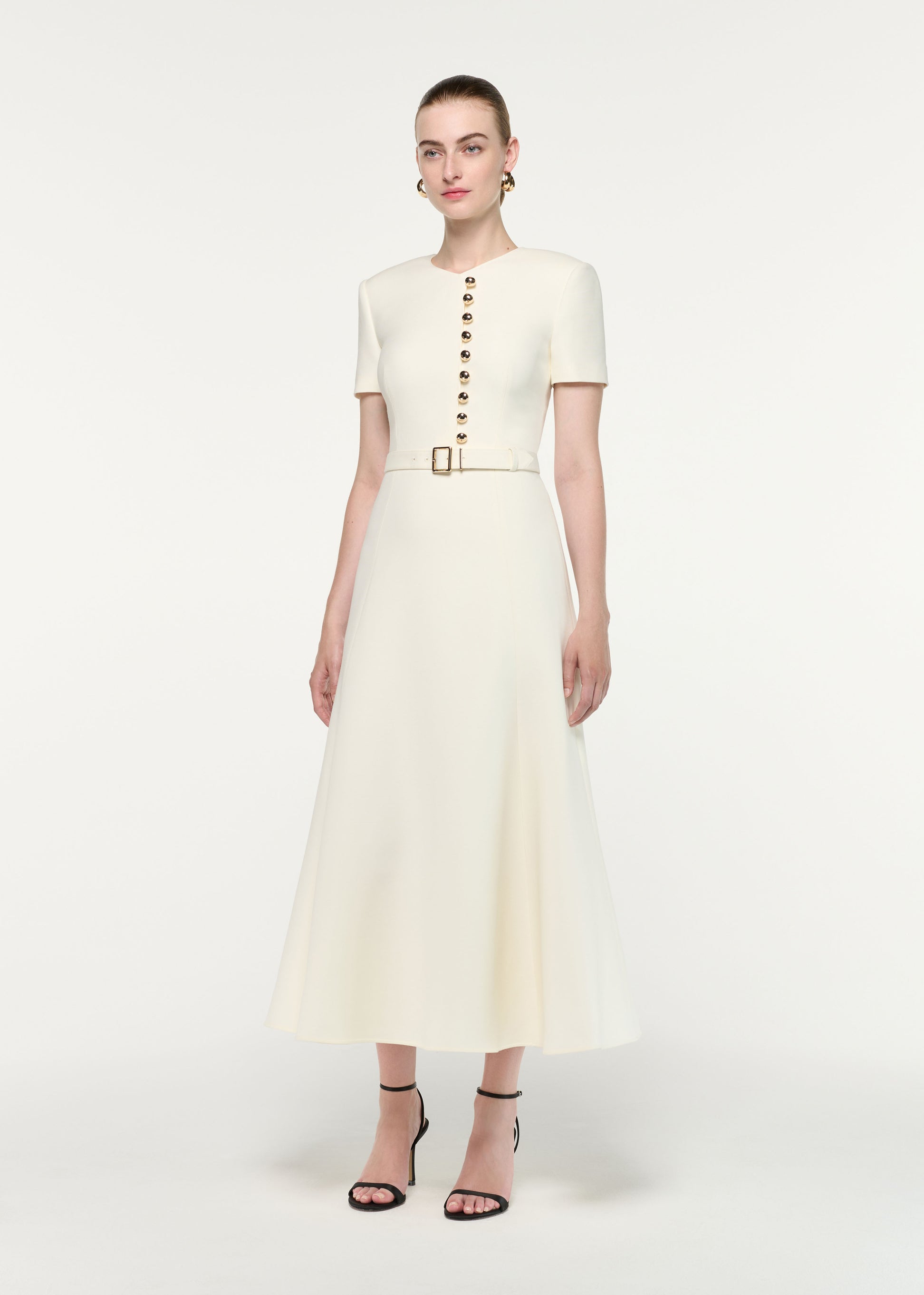 Side view of a model wearing the Gold Button Wool Silk Midi Dress