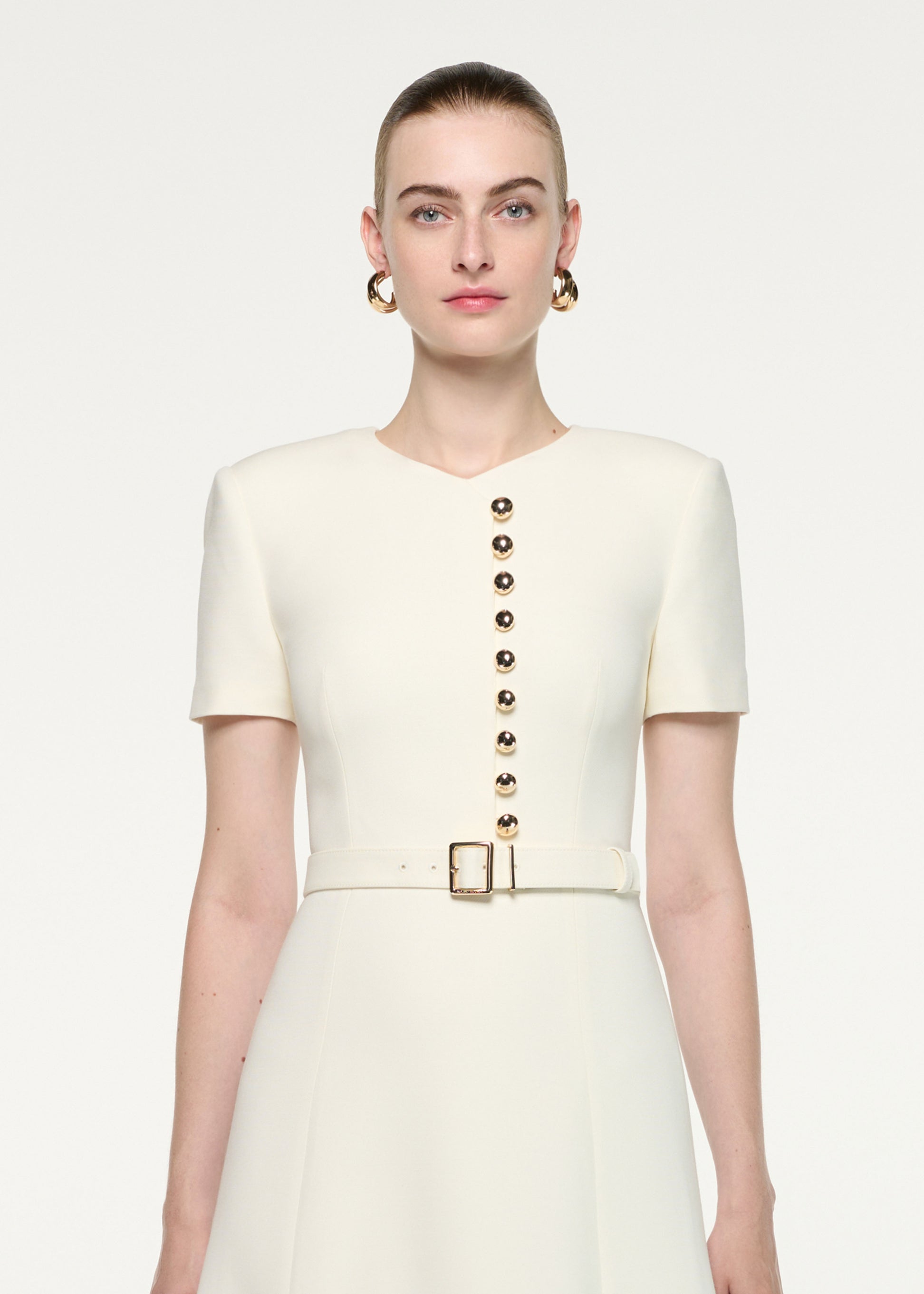Close up of a model wearing the Gold Button Wool Silk Midi Dress
