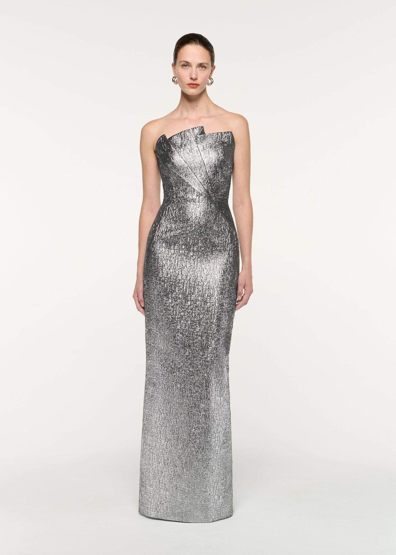 Front view of a model wearing the Pleated Strapless Metallic Jacquard Gown