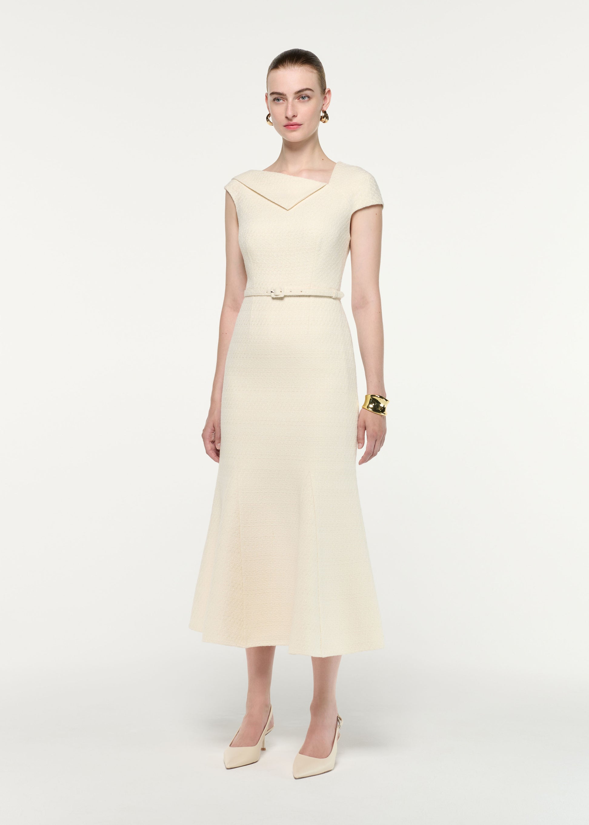 Side view of a model wearing the Asymmetric Neckline Boucle Midi Dress