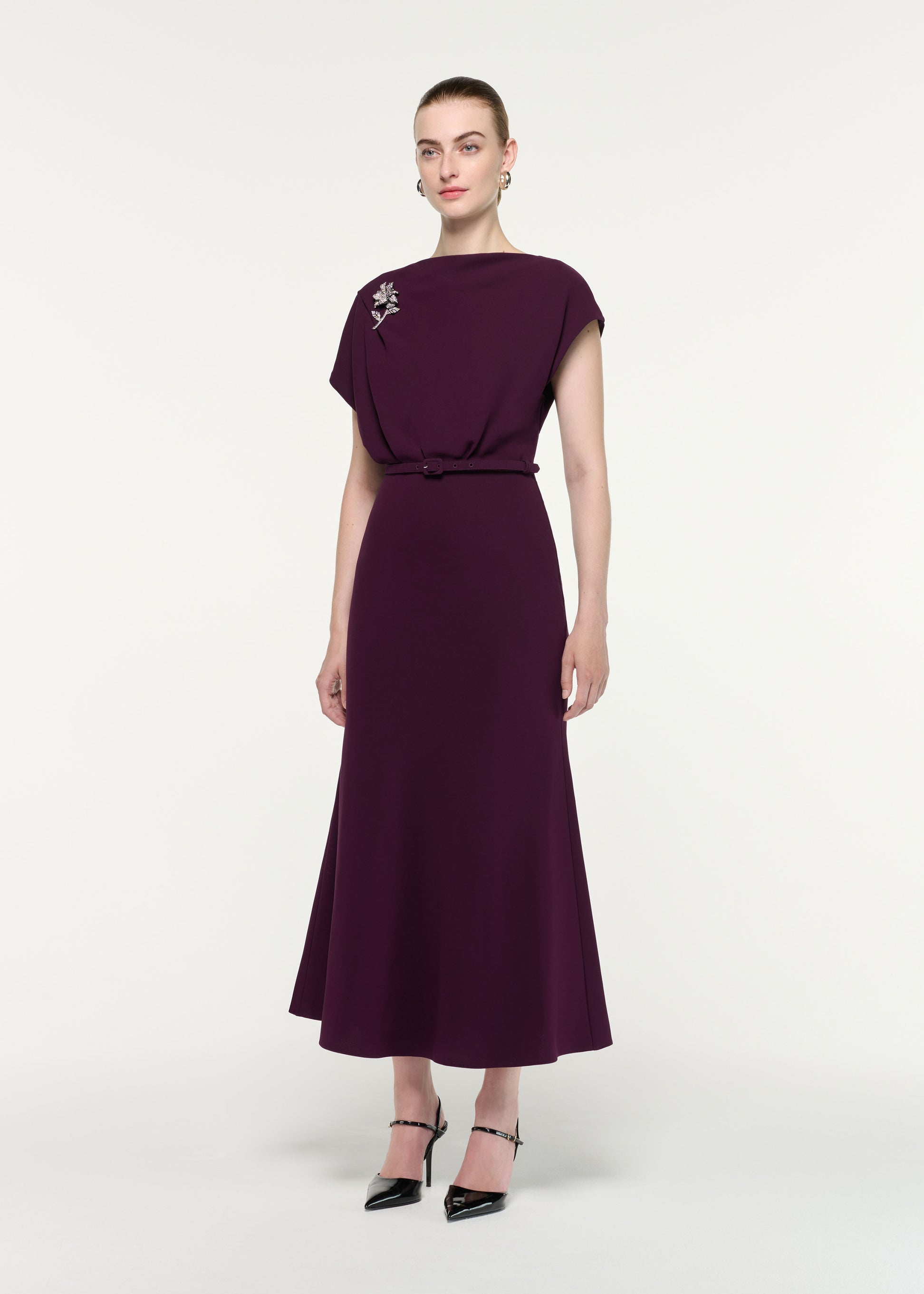 Side view of a model wearing the Flower Brooch Cady Midi Dress