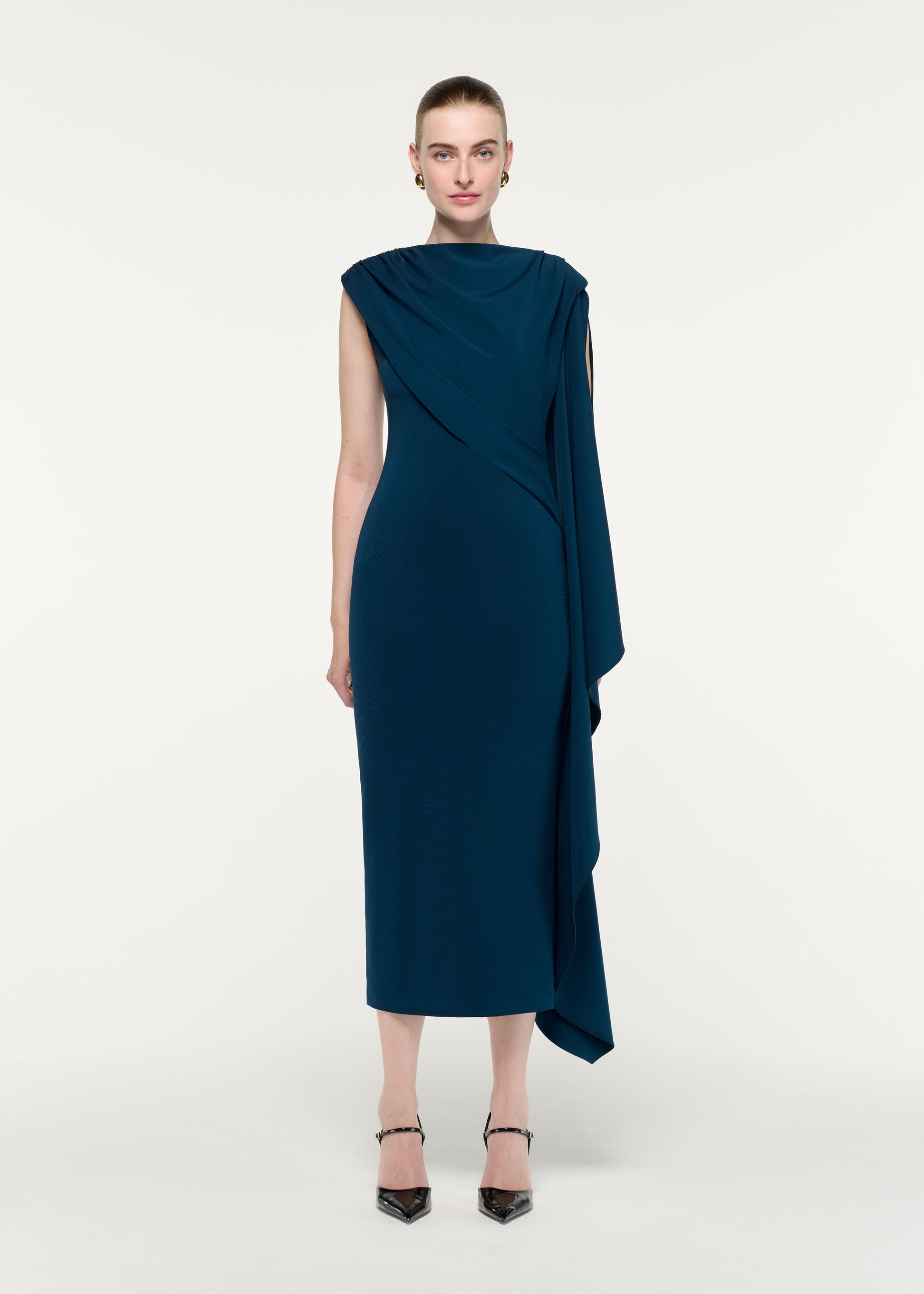 Front view of a model wearing the Asymmetric Cape Jersey Midi Dress