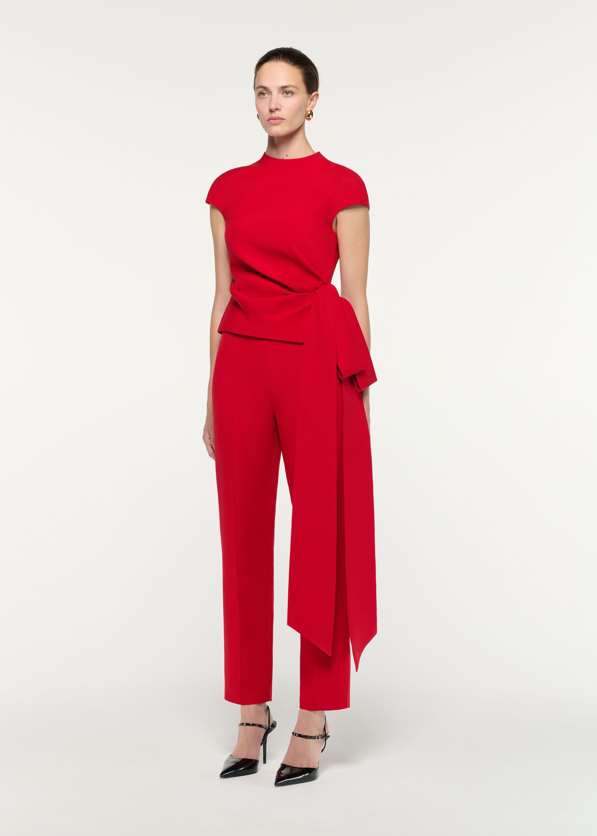 Side view of a model wearing the High Neck Wool Silk Bow Detail Top