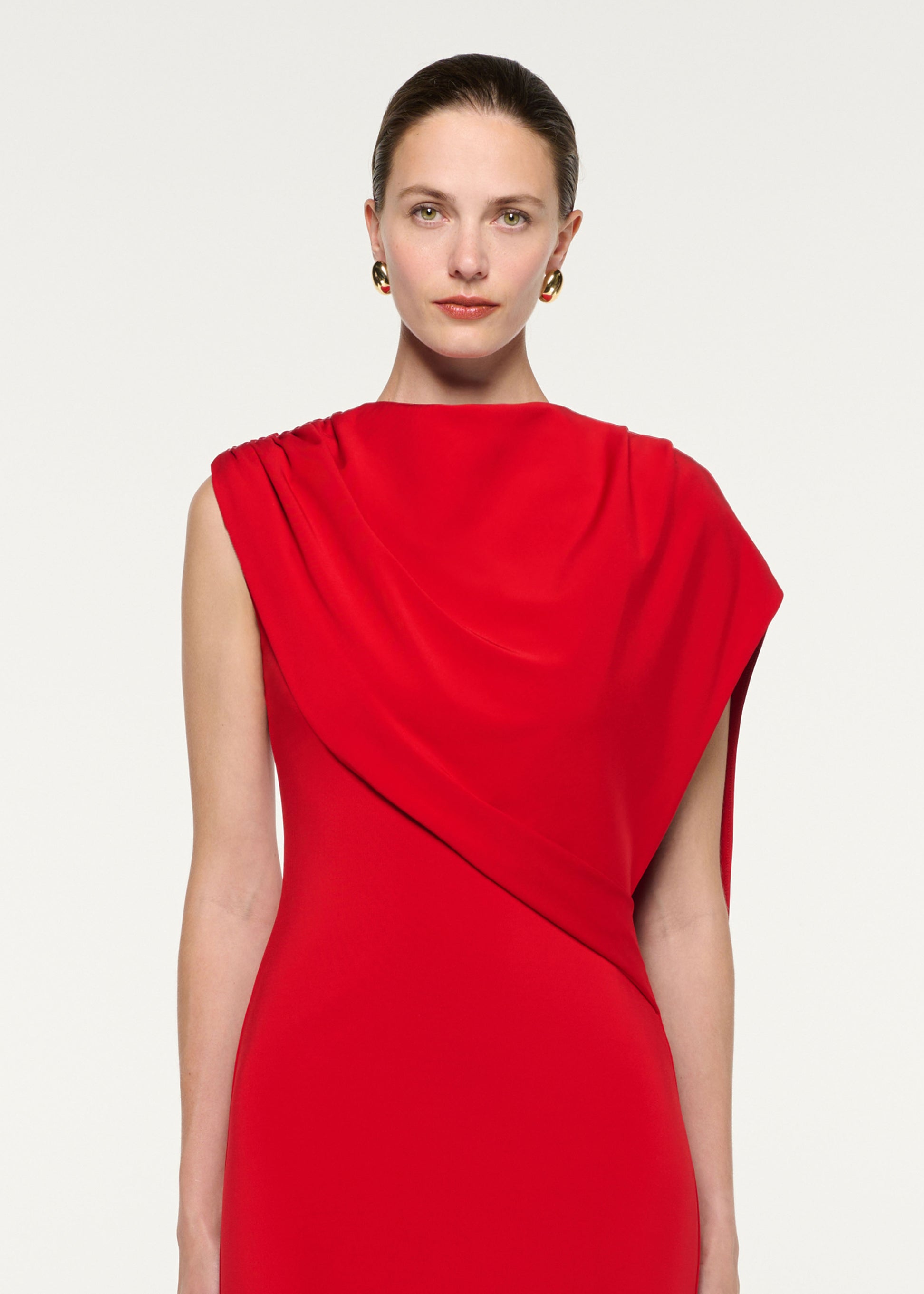 Close up of a model wearing the Asymmetric Cape Gown